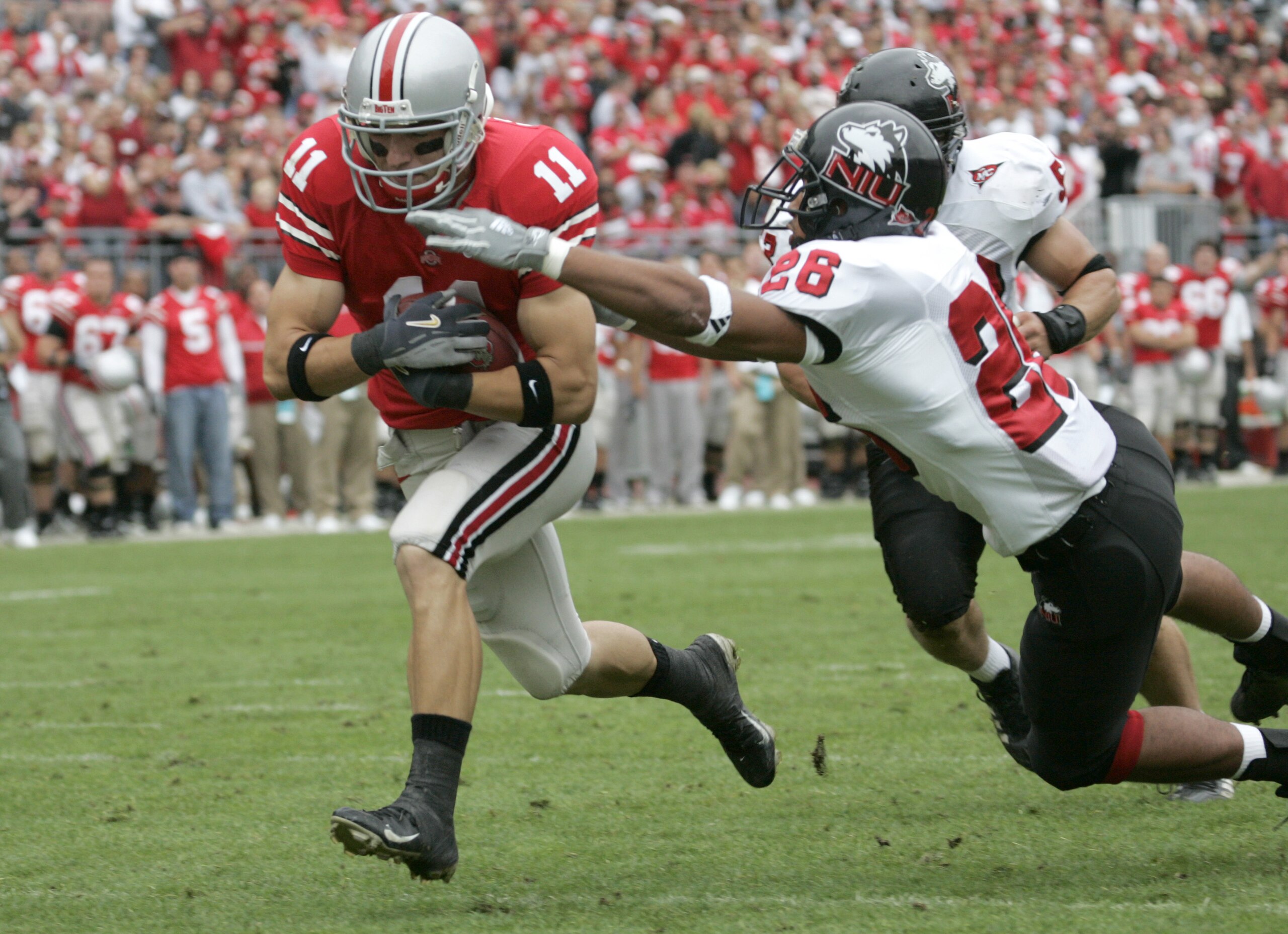 COLUMBUS, OH - SEPTEMBER 2:  Split end Anthony Gonzalez #11 of the Ohio State University Buckeyes evades linebacker Cory Hanson #26 against the Northern Illinois University Huskies during the game on September 2, 2006 at Ohio Stadium in Columbus, Ohio. OS