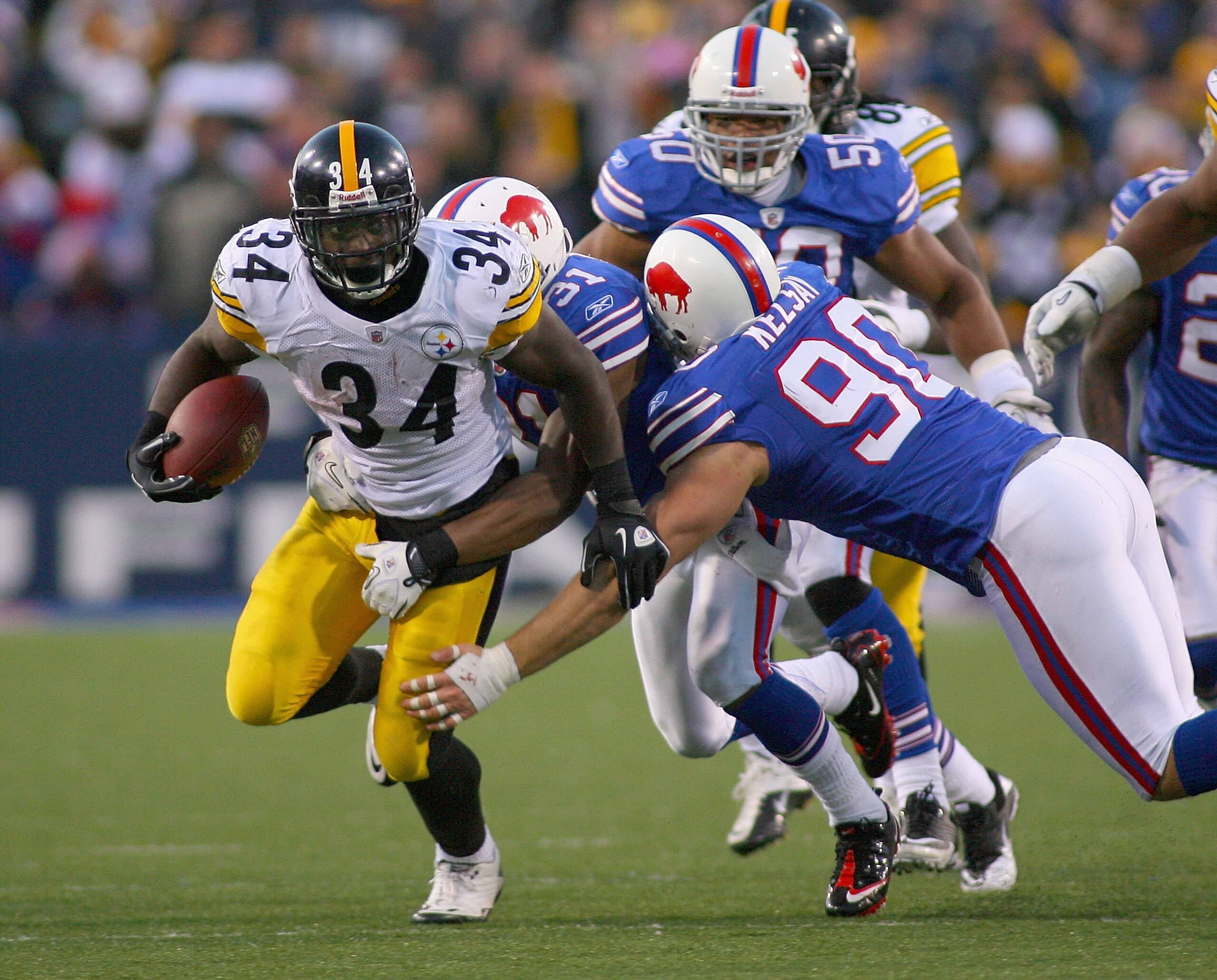 ORCHARD PARK, NY - NOVEMBER 28:  Rashard Mendenhall #34 of the Pittsburgh Steelers runs is tackled by Chris Kelsay #90 and Jairus Byrd #31 of the Buffalo Bills at Ralph Wilson Stadium at Ralph Wilson Stadium on November 28, 2010 in Orchard Park, New York.