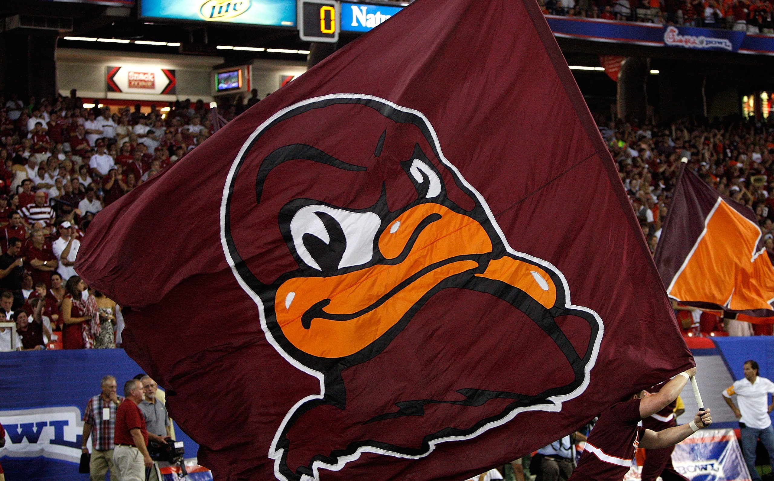 ATLANTA - SEPTEMBER 05:   A cheerleader runs a flag for the Virginia Tech Hokies across the field against the Alabama Crimson Tide during the Chick-fil-A Kickoff Game at Georgia Dome on September 5, 2009 in Atlanta, Georgia.  (Photo by Kevin C. Cox/Getty
