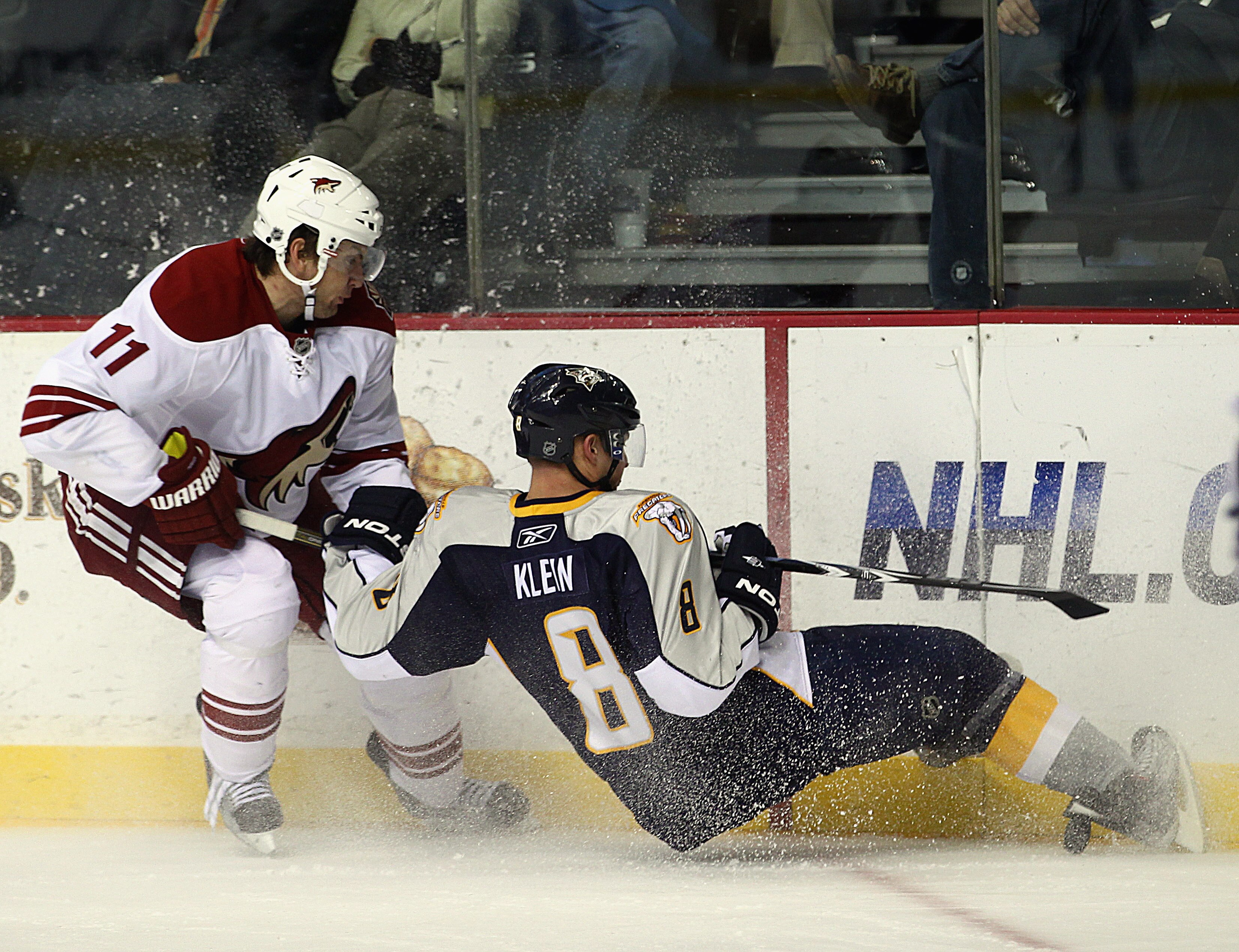 NASHVILLE, TN - NOVEMBER 30: Martin Hanzal #11 of the Phoenix Coyotes trips up Kevin Klein #8 of the Nashville Predators at the Bridgestone Arena on November 30, 2010 in Nashville, Tennessee. The Predators defeated the Coyotes 3-0. (Photo by Bruce Bennett