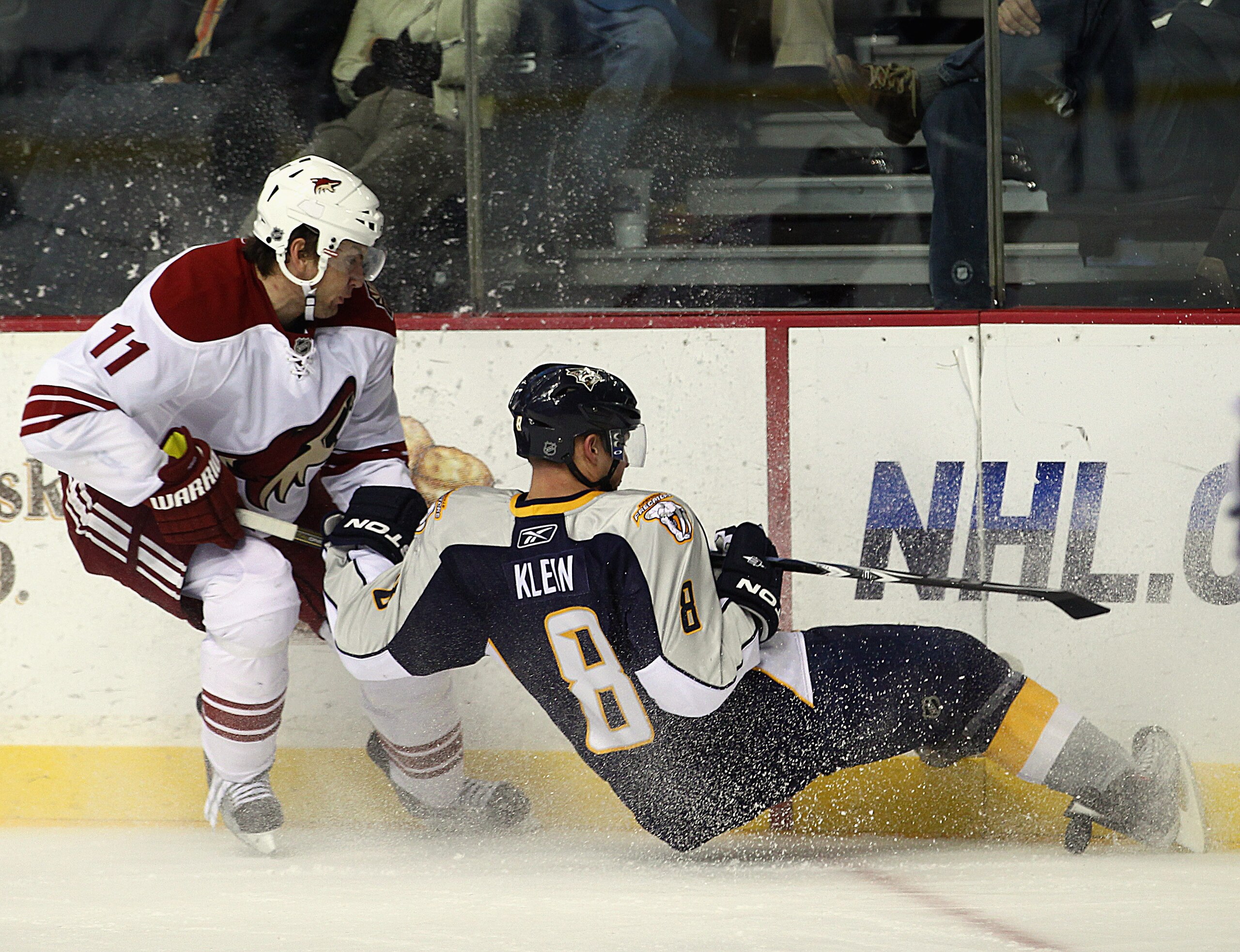 NASHVILLE, TN - NOVEMBER 30: Martin Hanzal #11 of the Phoenix Coyotes trips up Kevin Klein #8 of the Nashville Predators at the Bridgestone Arena on November 30, 2010 in Nashville, Tennessee. The Predators defeated the Coyotes 3-0. (Photo by Bruce Bennett