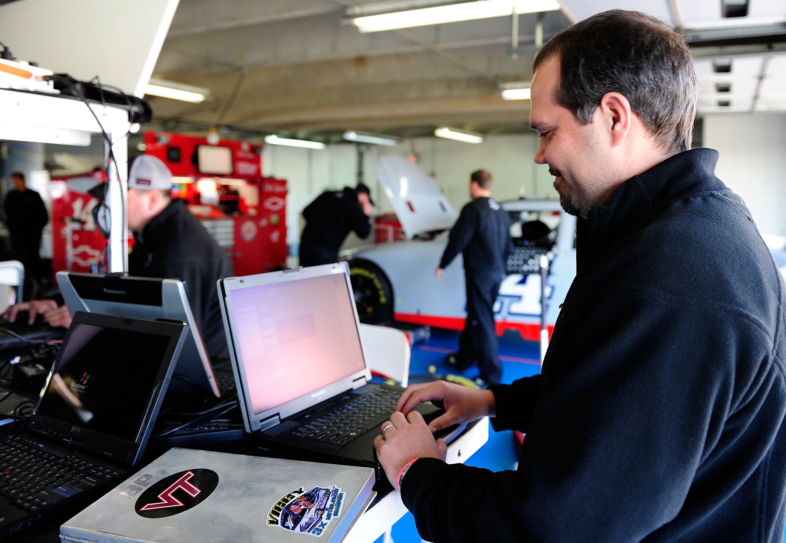 CONCORD, NC - MARCH 24:  Darian Grubb, crew chief for the #14 Steart Haas Chevrolet, enters data in a computer in the garage during NASCAR Sprint Cup Series testing at Charlotte Motor Speedway on March 24, 2010 in Concord, North Carolina.  (Photo by Rusty