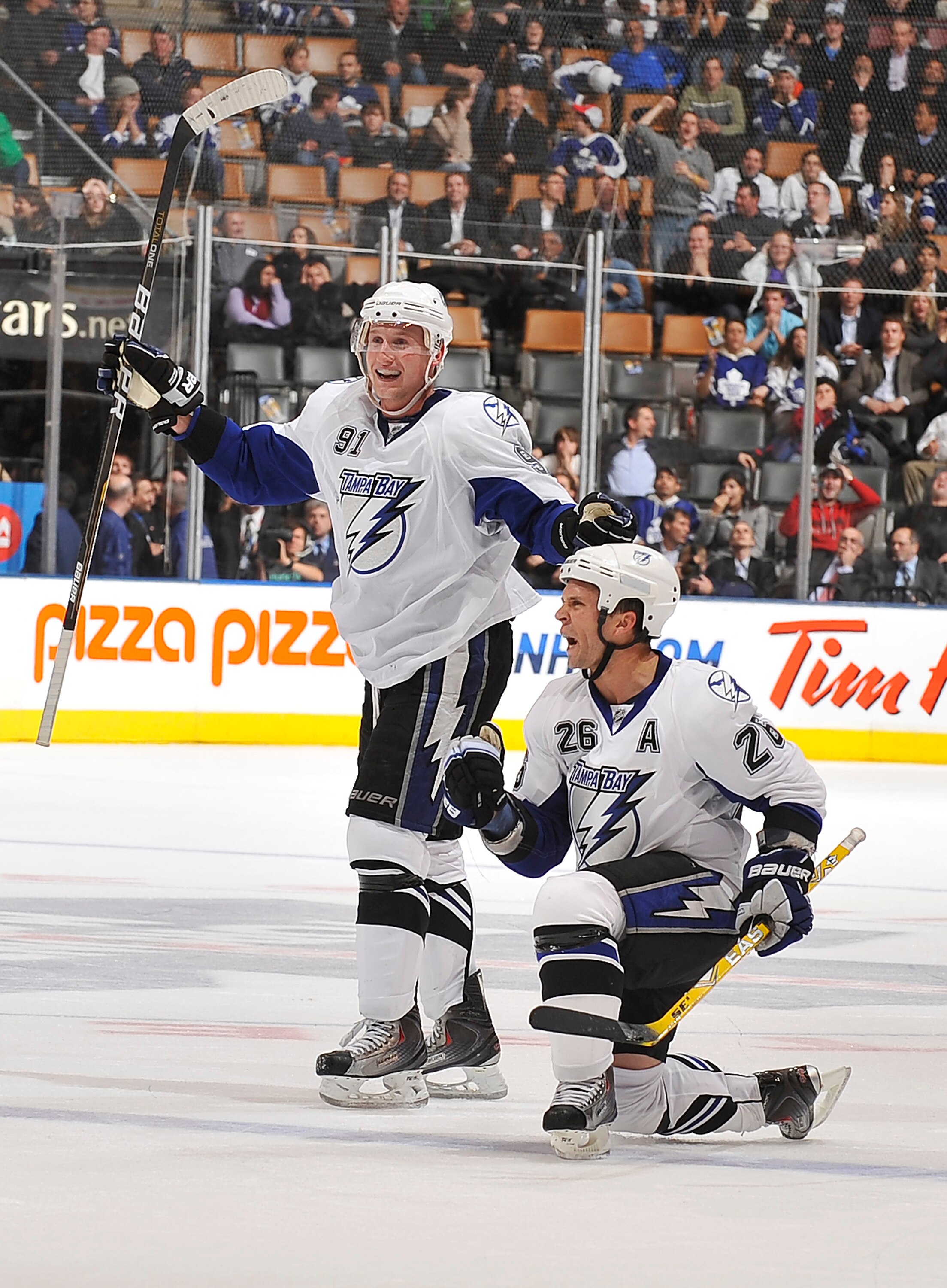 TORONTO, CANADA - NOVEMBER 30:  Steven Stamkos #91 and Martin St. Louis #26 of the Tampa Bay Lightning celebrate a late third period goal against the Toronto Maple Leafs during game action November 30, 2010 at the Air Canada Centre in Toronto, Ontario, Ca