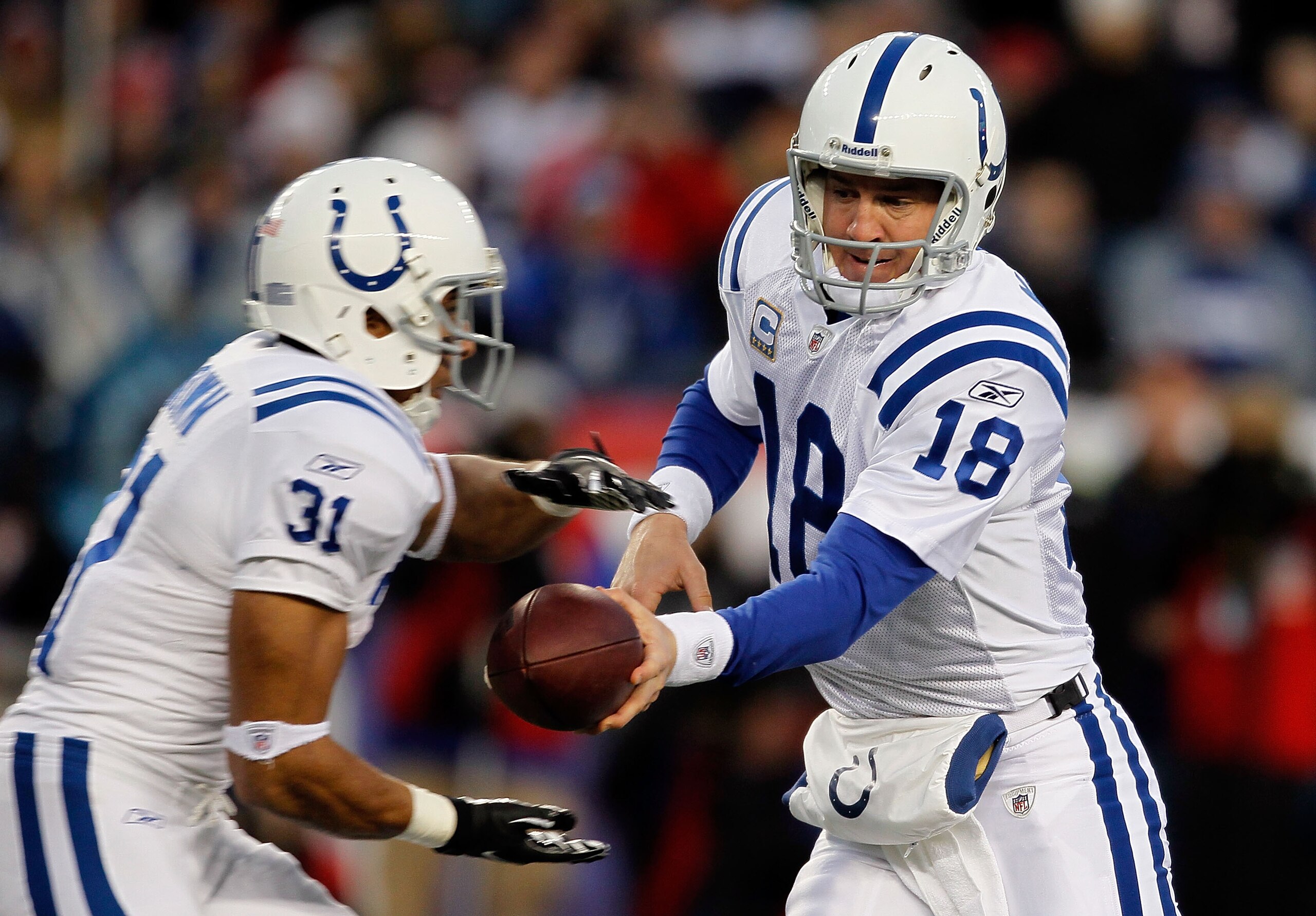 FOXBORO, MA - NOVEMBER 21: Peyton Manning #18 of the Indianapolis Colts hands the ball to teammate Donald Brown #31 against the New England Patriots at Gillette Stadium on November 21, 2010 in Foxboro, Massachusetts. (Photo by Jim Rogash/Getty Images) FOXBORO, MA - NOVEMBER 21: Peyton Manning #18 of the Indianapolis Colts hands the ball to teammate Donald Brown #31 against the New England Patriots at Gillette Stadium on November 21, 2010 in Foxboro, Massachusetts. (Photo by Jim Rogash/Getty Images)