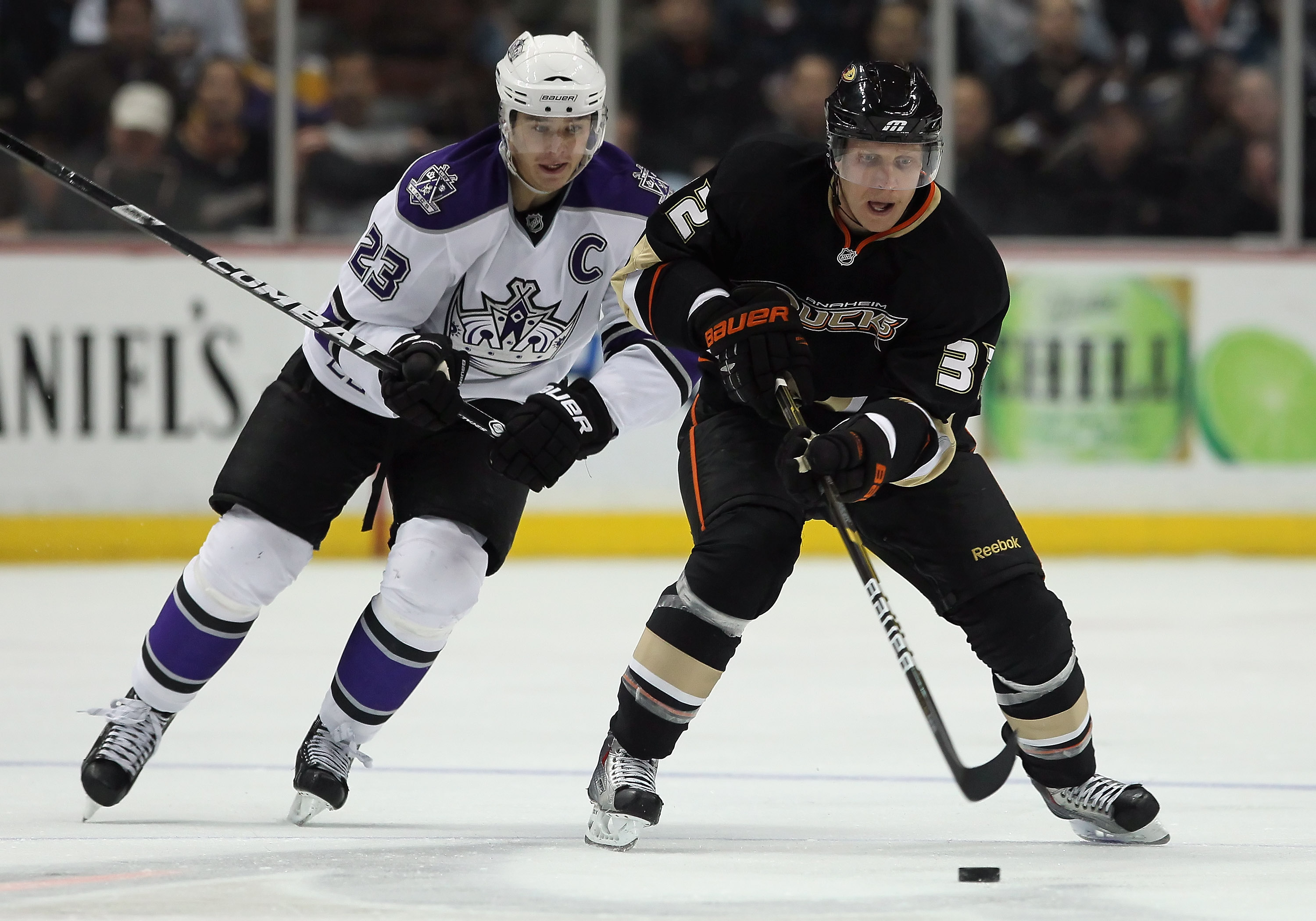 ANAHEIM, CA - NOVEMBER 29:  Toni Lydman #32 of the Anaheim Ducks is pursued by Dustin Brown #23 of the Los Angeles Kings during the third period at the Honda Center on November 29, 2010 in Anaheim, California. The Ducks defeated the Kings  2-0.  (Photo by