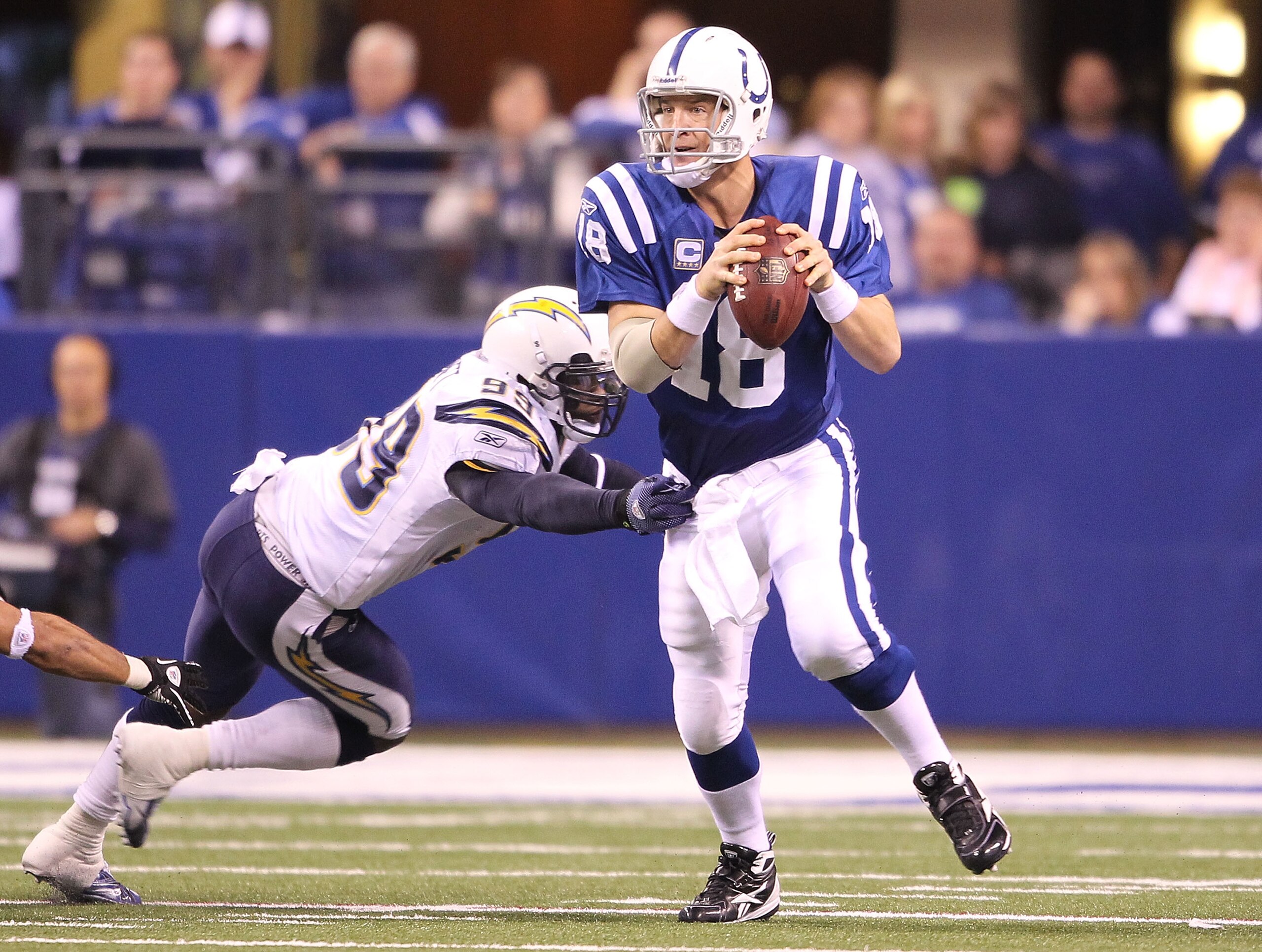 INDIANAPOLIS - NOVEMBER 28: Peyton Manning #18 of the Indianapolis Colts looks to throw a pass while pursued by Kevin Burnett #99 of the San Diego Chargers during the NFL game at Lucas Oil Stadium on November 28, 2010 in Indianapolis, Indiana. The Charg INDIANAPOLIS - NOVEMBER 28: Peyton Manning #18 of the Indianapolis Colts looks to throw a pass while pursued by Kevin Burnett #99 of the San Diego Chargers during the NFL game at Lucas Oil Stadium on November 28, 2010 in Indianapolis, Indiana. The Charg