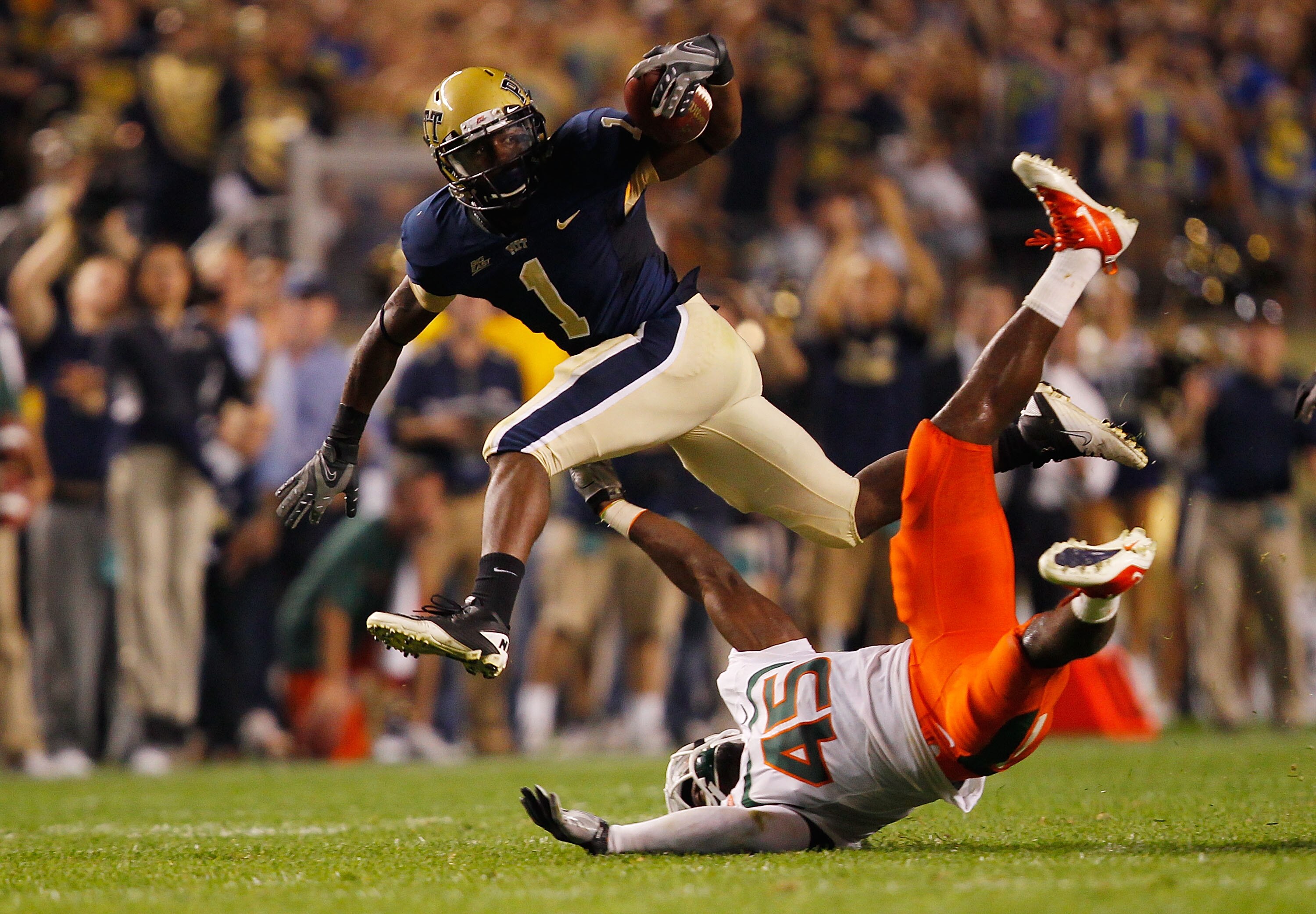PITTSBURGH - SEPTEMBER 23:  Ray Graham #1 of the Pittsburgh Panthers evades a tackle by Ramon Buchanan #45 of the Miami Hurricanes on September 23, 2010 at Heinz Field in Pittsburgh, Pennsylvania.  (Photo by Jared Wickerham/Getty Images)