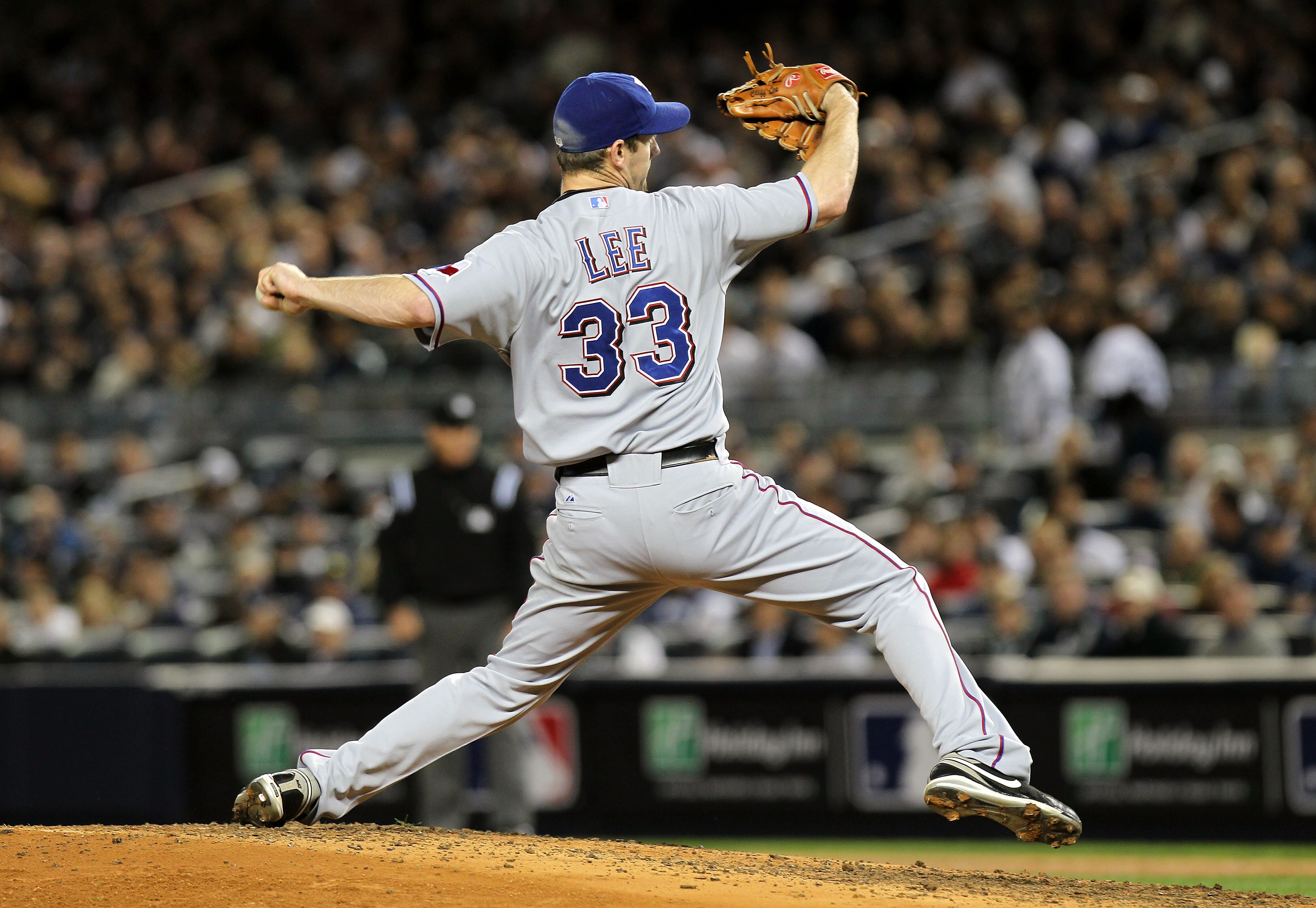 NEW YORK - OCTOBER 18:  Cliff Lee #33 of the Texas Rangers pitches against the New York Yankees  in Game Three of the ALCS during the 2010 MLB Playoffs at Yankee Stadium on October 18, 2010 in New York, New York.  (Photo by Nick Laham/Getty Images)