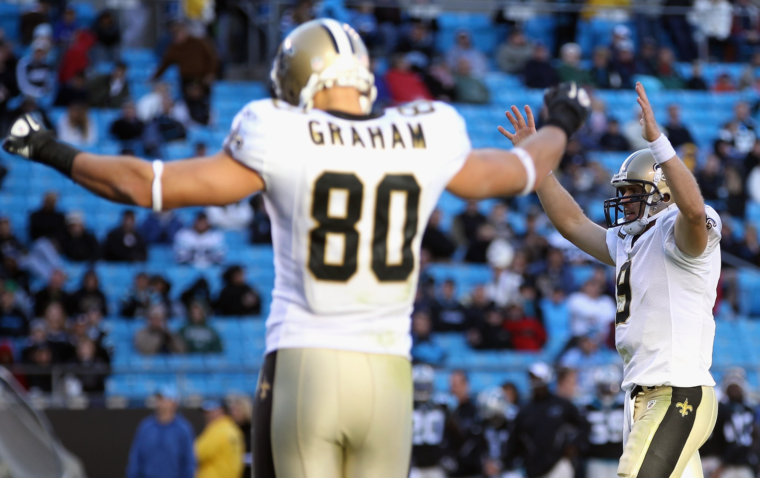 CHARLOTTE, NC - NOVEMBER 07:  Teammates Drew Brees #9 and Jimmy Graham #80 of the New Orleans Saints celebrate after a touchdown against the Carolina Panthers during their game at Bank of America Stadium on November 7, 2010 in Charlotte, North Carolina.