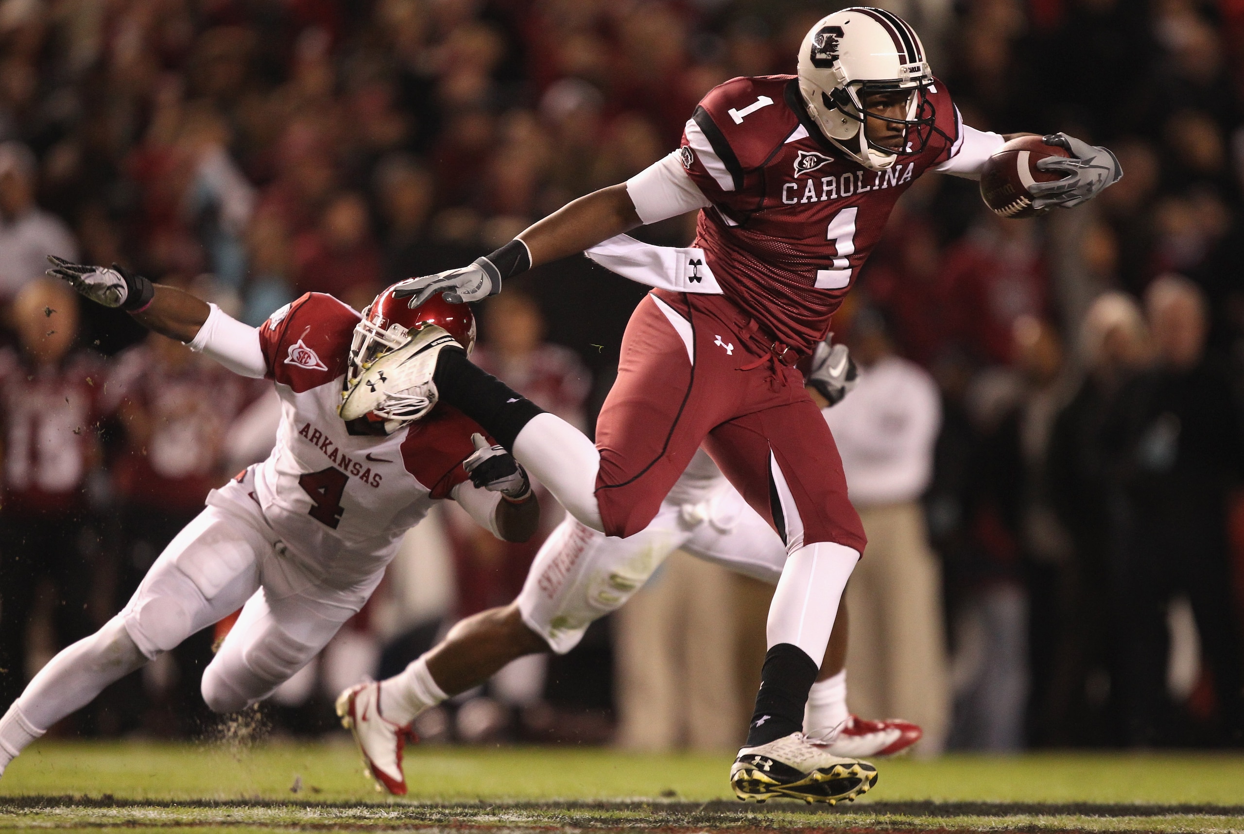 COLUMBIA, SC - NOVEMBER 06:  Teammates Rudell Crim #4 and Ramon Brown #26 of the Arkansas Razorbacks try to stop Alshon Jeffery #1 of the South Carolina Gamecocks during their game at Williams-Brice Stadium on November 6, 2010 in Columbia, South Carolina.
