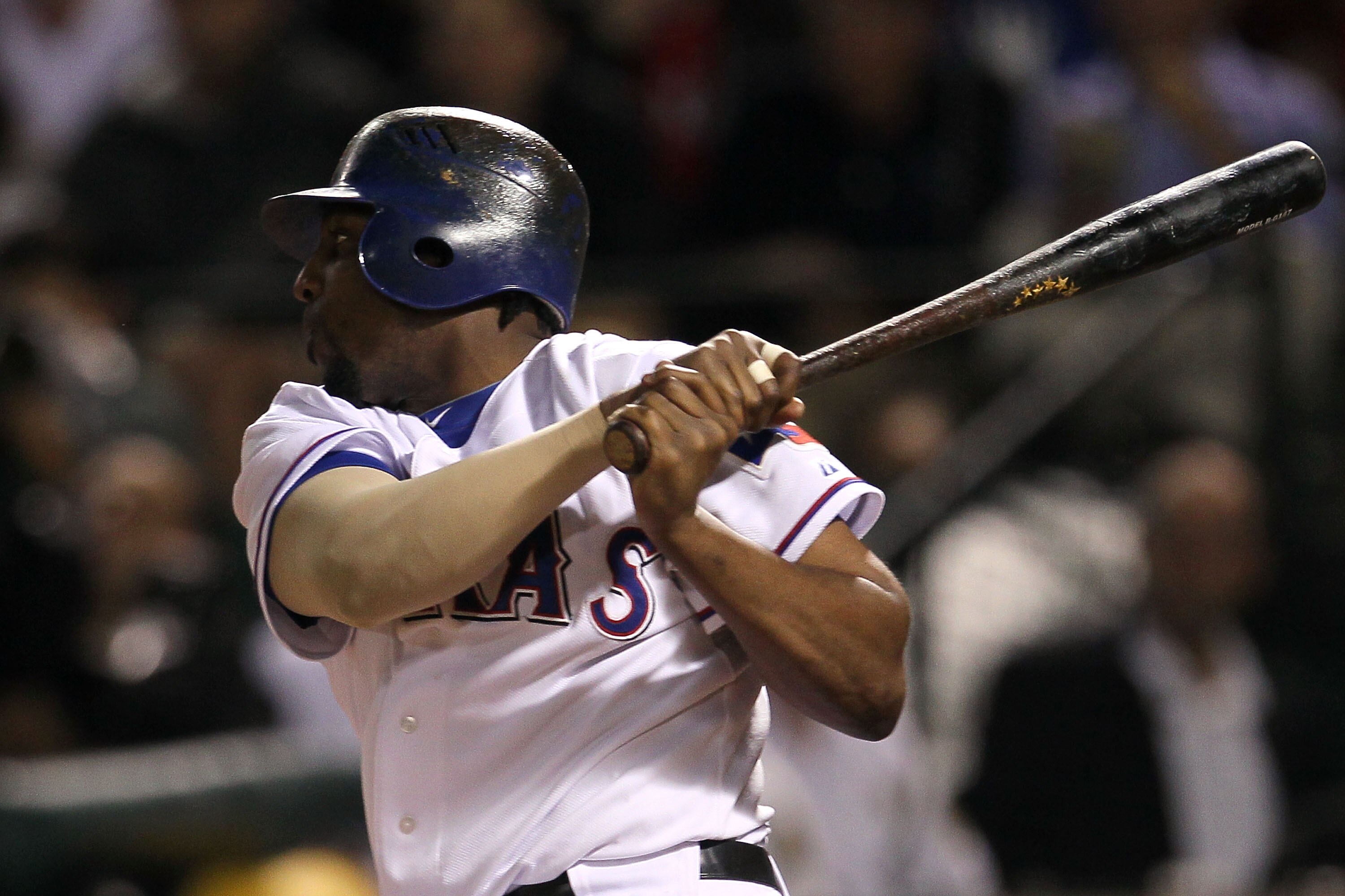 ARLINGTON, TX - OCTOBER 22:  Vladimir Guerrero #27 of the Texas Rangers hits a sacrifice ground ball to score Elvis Andrus #1 in the first inning of Game Six of the ALCS against the New York Yankees during the 2010 MLB Playoffs at Rangers Ballpark in Arli