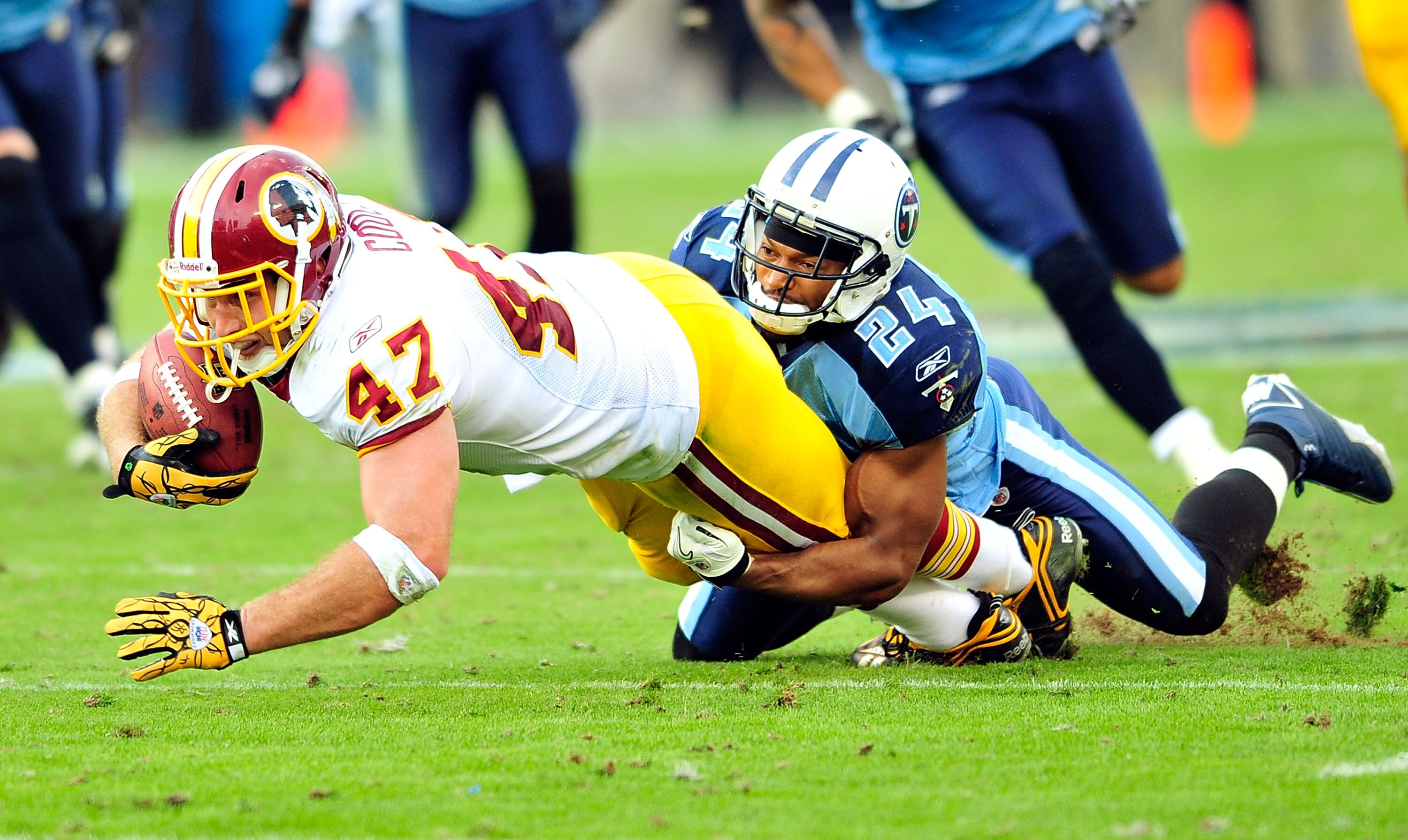 NASHVILLE, TN - NOVEMBER 21:  Chris Hope #24 of the Tennessee Titans tackles Chris Cooley #47 of the Washington Redskins at LP Field on November 21, 2010 in Nashville, Tennessee. The Redskins won 19-16 in overtime.  (Photo by Grant Halverson/Getty Images)