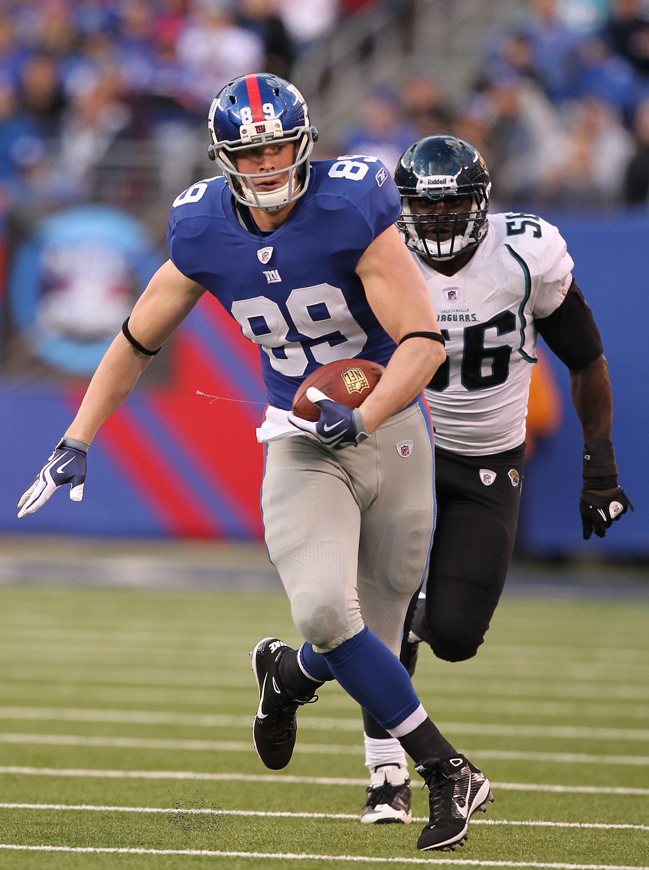 EAST RUTHERFORD, NJ - NOVEMBER 28:  Kevin Boss #89  of the New York Giants runs with the ball as Justin Durant #56 of the Jacksonville Jaguars trails during their game on November 28, 2010 at The New Meadowlands Stadium in East Rutherford, New Jersey.  (P