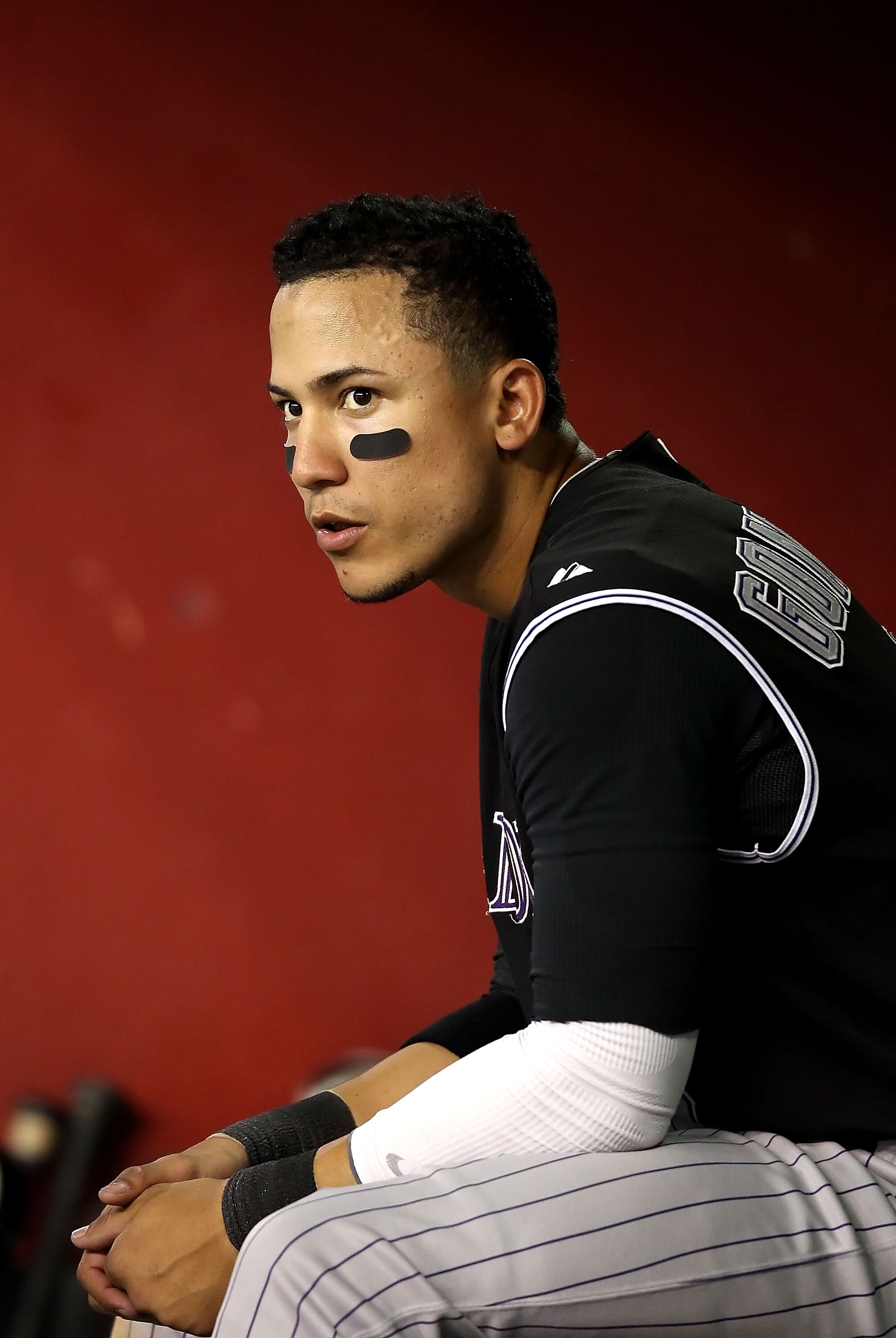 PHOENIX - SEPTEMBER 22:  Carlos Gonzalez #5 of the Colorado Rockies sits in the dugout during the Major League Baseball game against the Arizona Diamondbacks at Chase Field on September 22, 2010 in Phoenix, Arizona.  (Photo by Christian Petersen/Getty Ima