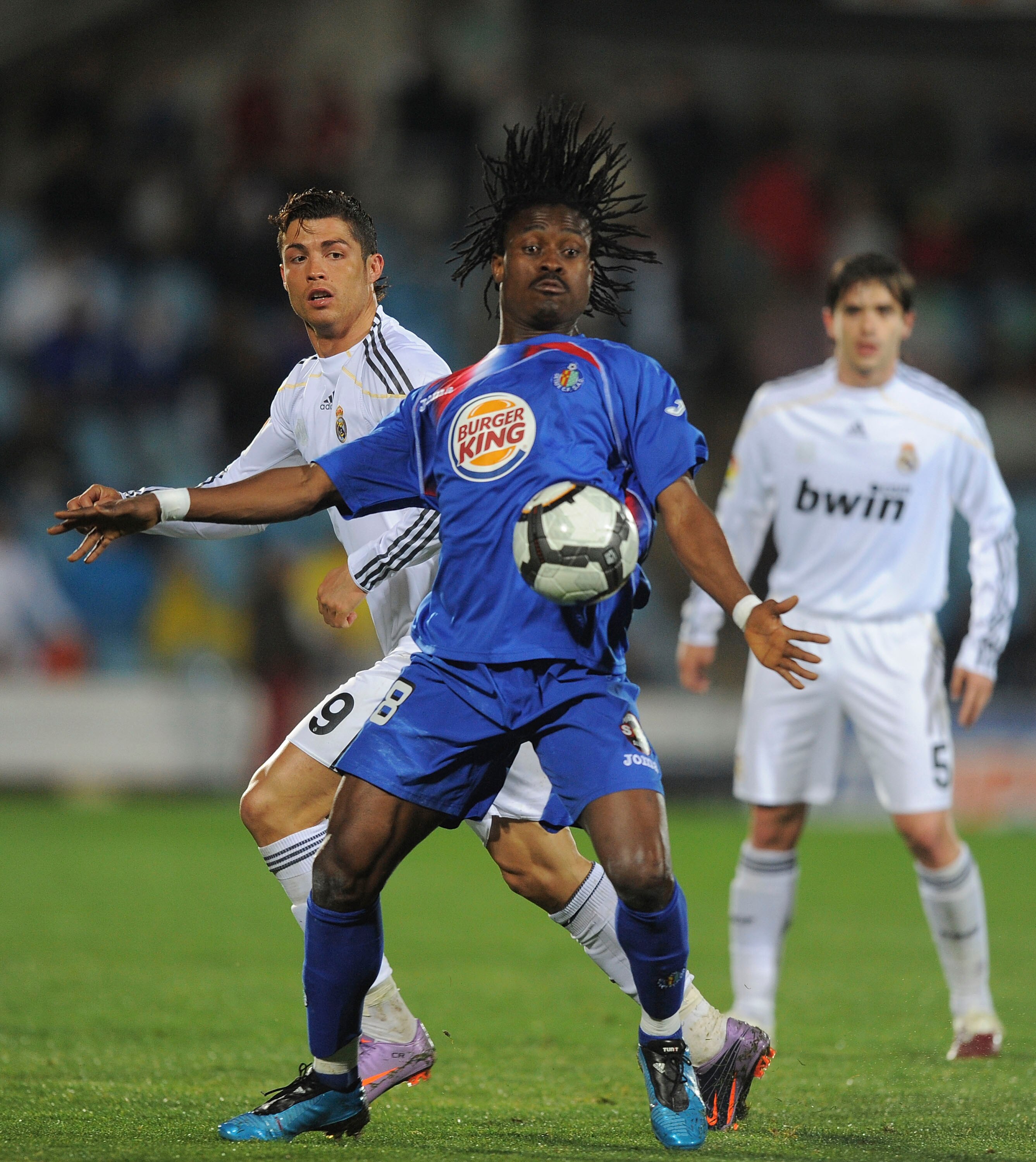GETAFE, SPAIN - MARCH 25:  Derek Boateng (R) of Getafe robs the ball from Cristiano Ronaldo of Real Madrid during La Liga match between Getafe and Real Madrid at the Coliseum Alfonso Perez stadium on March 25, 2010 in Getafe, Spain.  (Photo by Denis Doyle