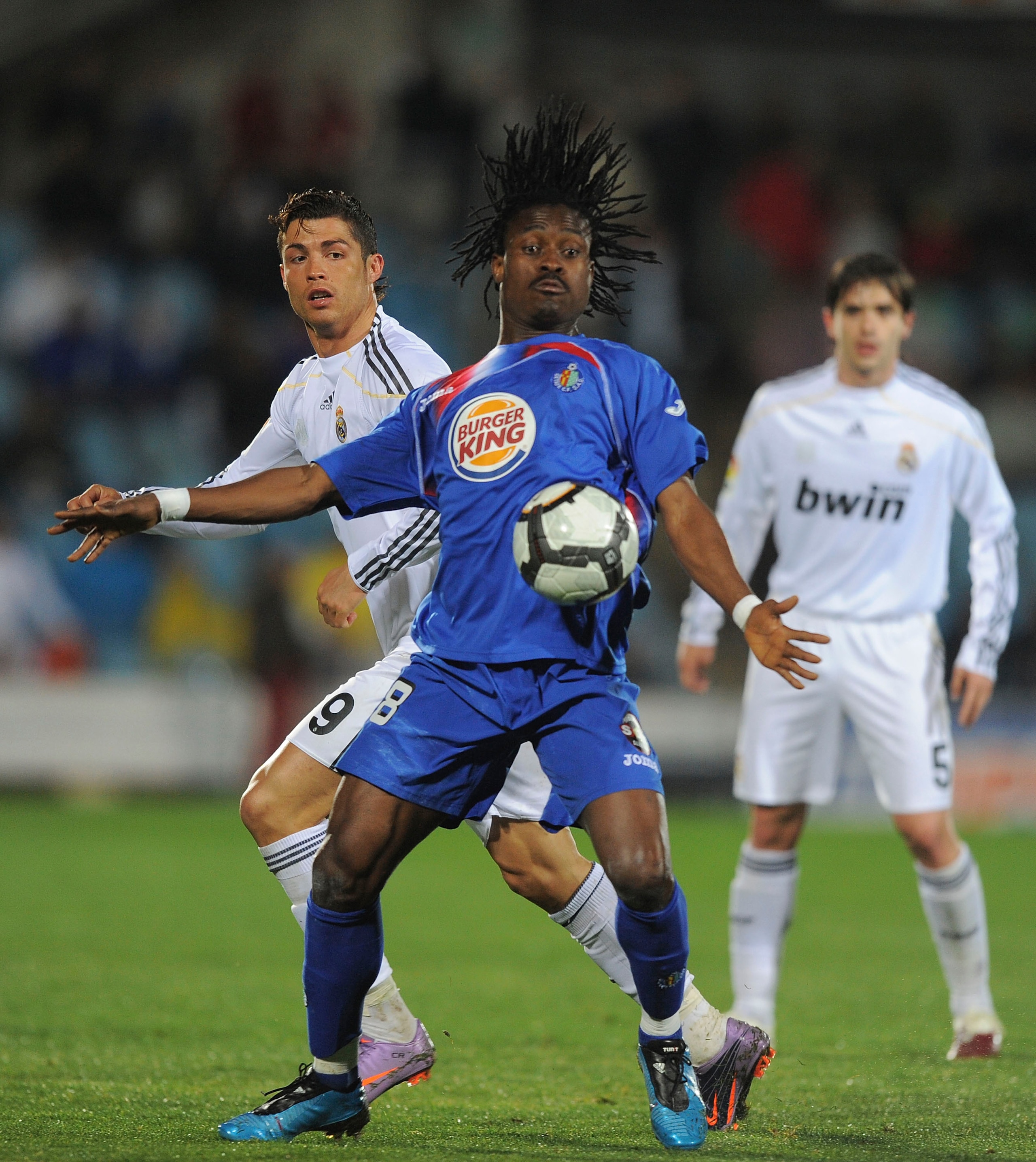 GETAFE, SPAIN - MARCH 25:  Derek Boateng (R) of Getafe robs the ball from Cristiano Ronaldo of Real Madrid during La Liga match between Getafe and Real Madrid at the Coliseum Alfonso Perez stadium on March 25, 2010 in Getafe, Spain.  (Photo by Denis Doyle