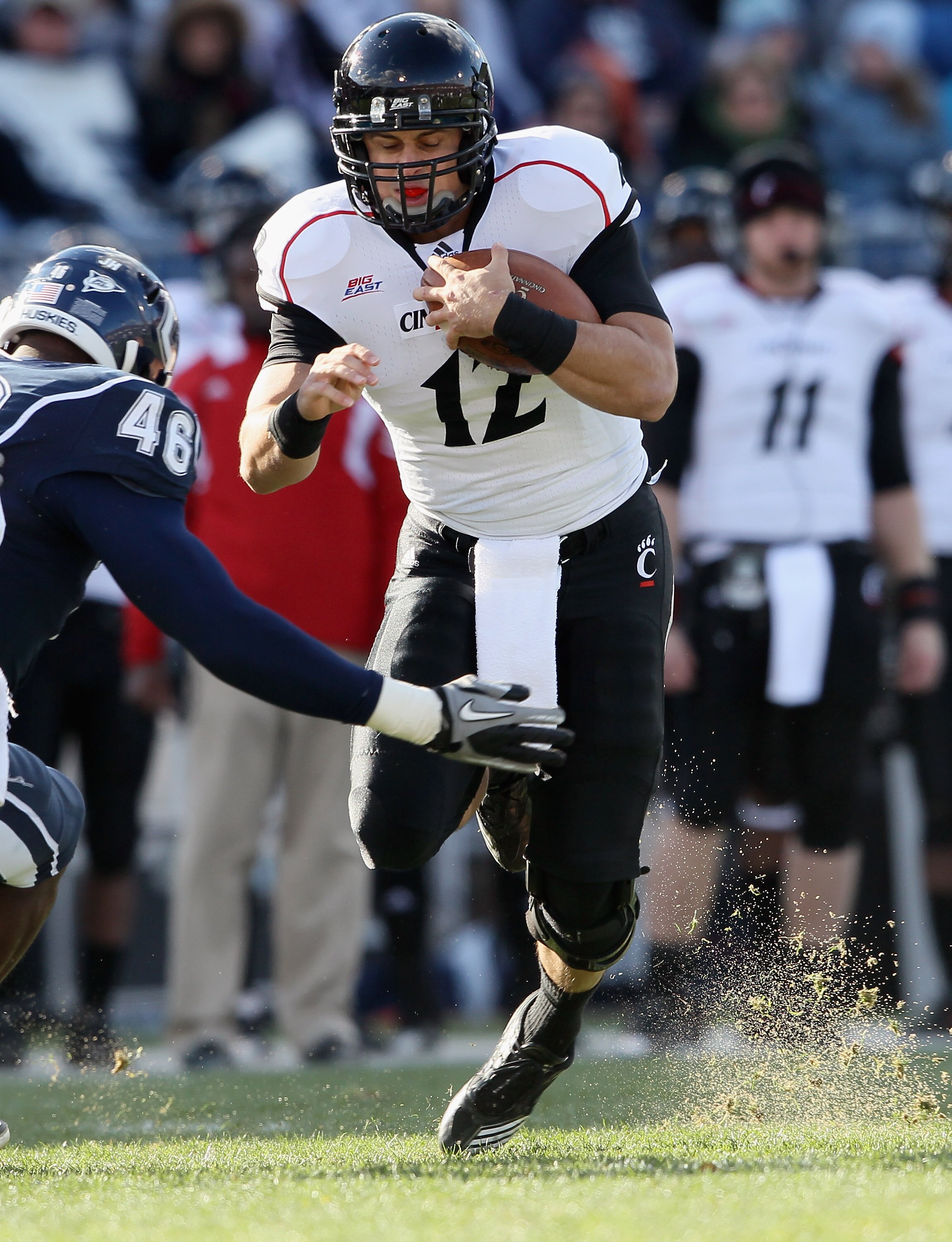 EAST HARTFORD, CT - NOVEMBER 27:  Zach Collaros #12 of the Cincinnati Bearcats is hit by Sio Moore #46 of the Connecticut Huskies on November 27, 2010 at Rentschler Field in East Hartford, Connecticut.  (Photo by Elsa/Getty Images)