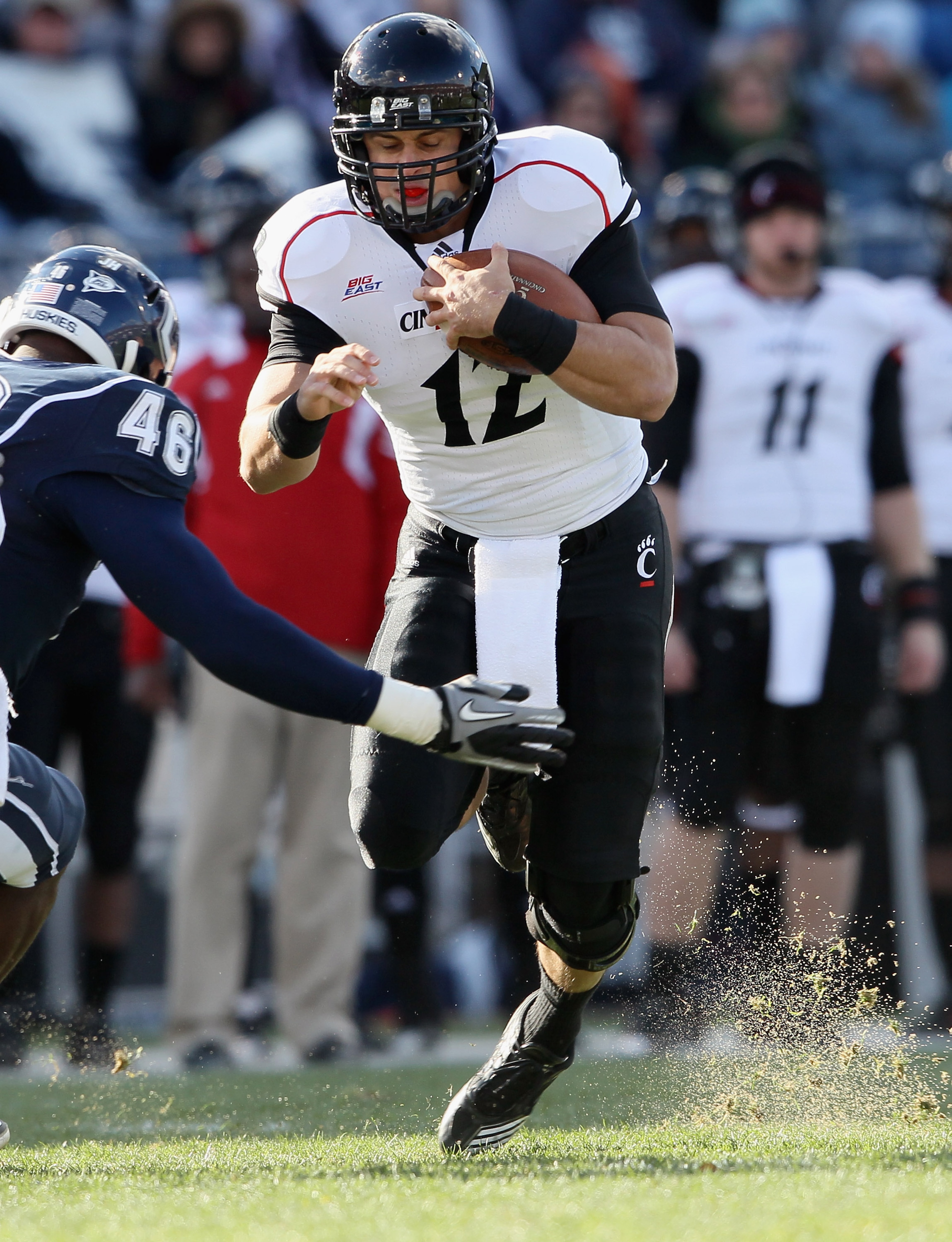 EAST HARTFORD, CT - NOVEMBER 27:  Zach Collaros #12 of the Cincinnati Bearcats is hit by Sio Moore #46 of the Connecticut Huskies on November 27, 2010 at Rentschler Field in East Hartford, Connecticut.  (Photo by Elsa/Getty Images)