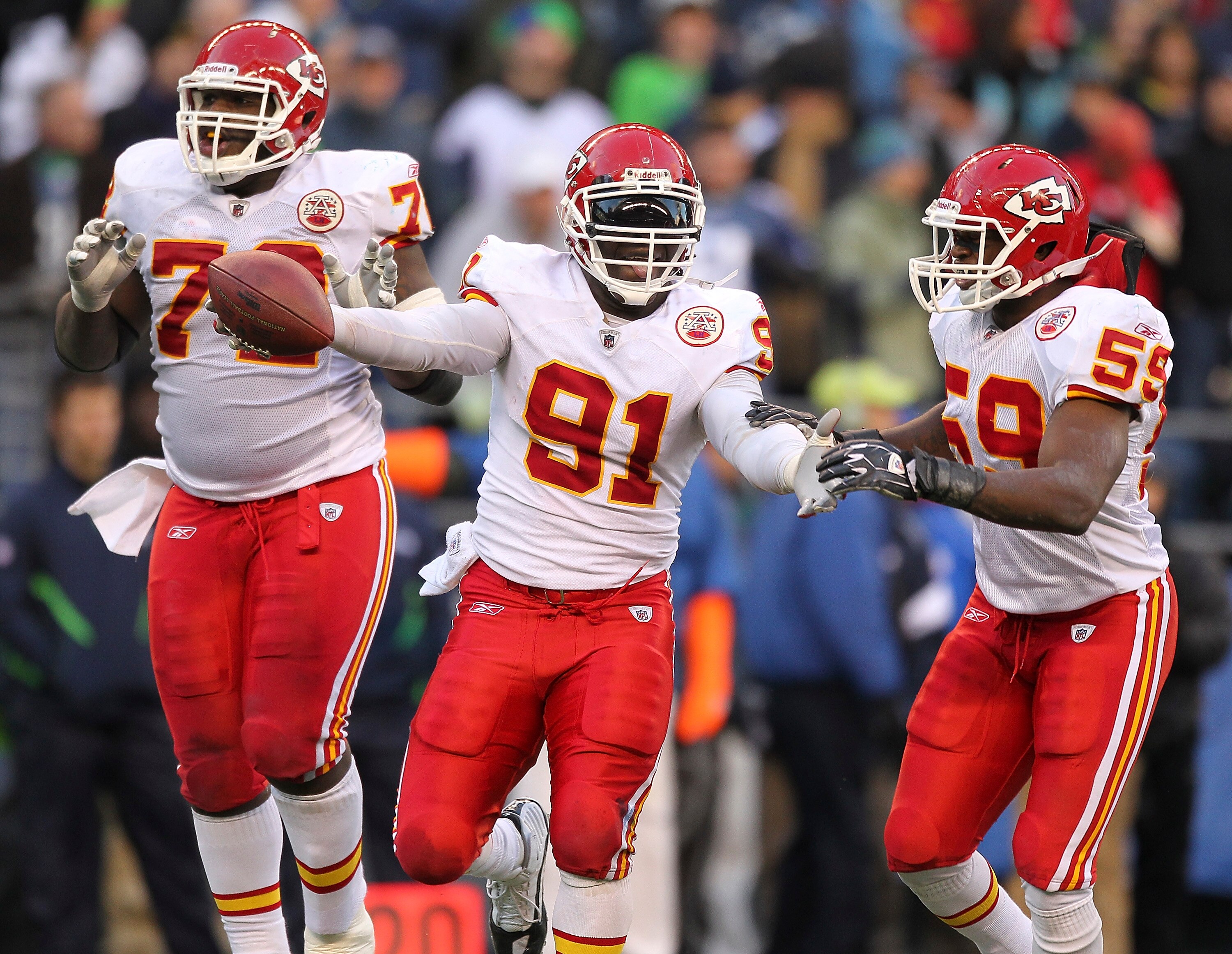 SEATTLE - NOVEMBER 28:  Linebacker Tamba Hali #91 of the Kansas City Chiefs celebrates with Glenn Dorsey #72 and Jovan Belcher #59 after recovering a fumble on a sack of quarterback Matt Hasselbeck of the Seattle Seahawks at Qwest Field on November 28, 20
