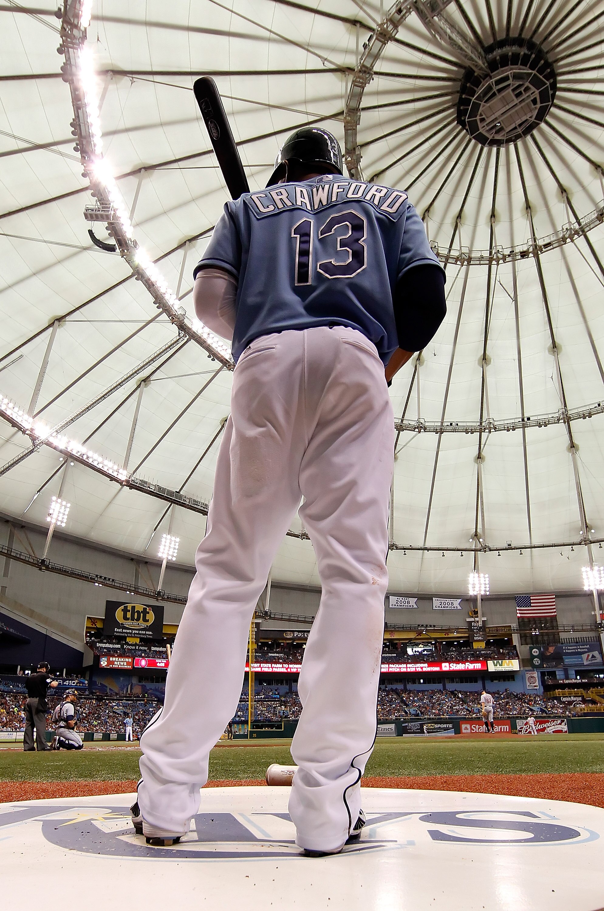 ST. PETERSBURG - JULY 11:  Designated hitter Carl Crawford #13 of the Tampa Bay Rays waits to bat against the Cleveland Indians at Tropicana Field on July 11, 2010 in St. Petersburg, Florida.  (Photo by J. Meric/Getty Images)