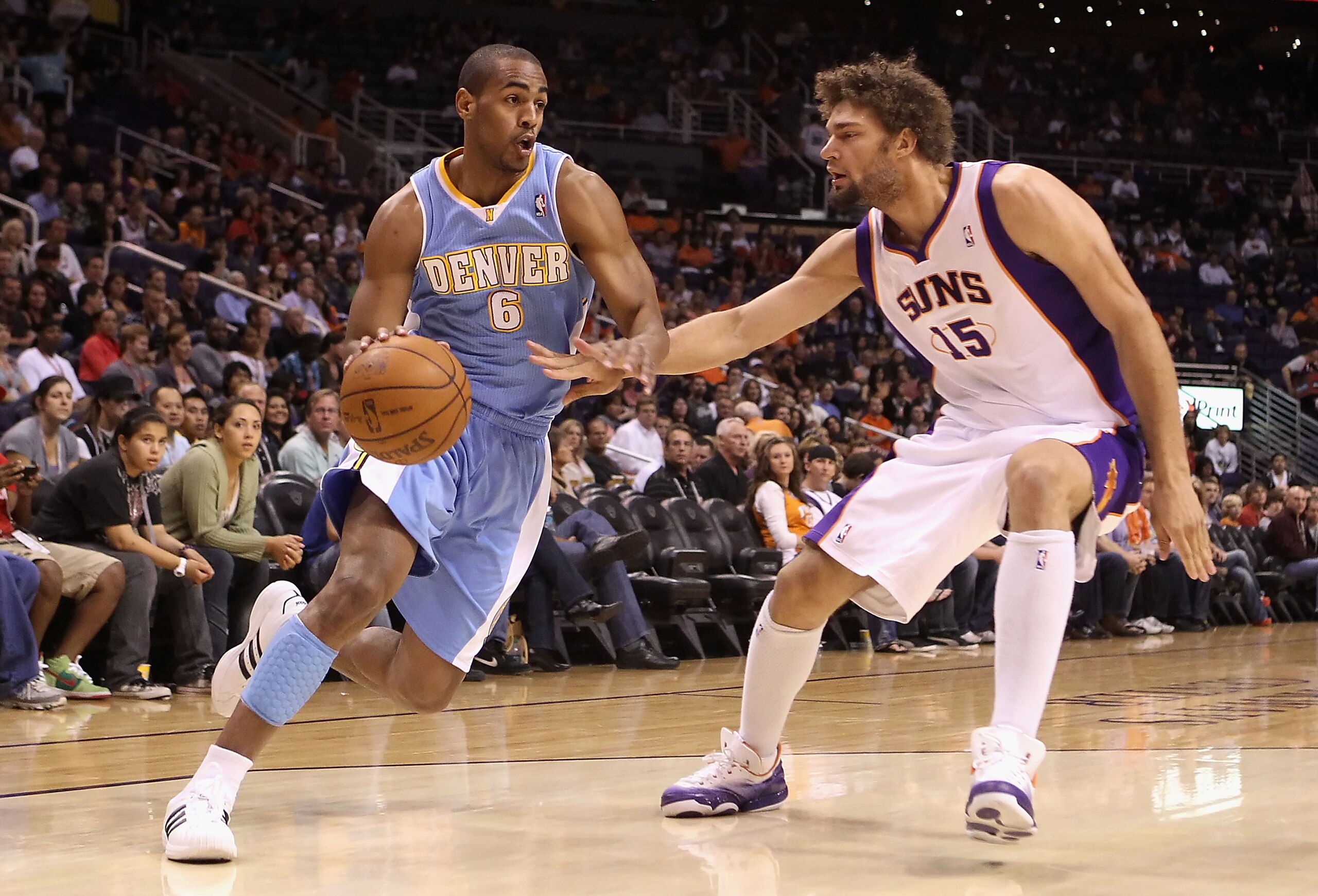 PHOENIX - OCTOBER 22:  Arron Afflalo #6 of the Denver Nuggets drives the ball against Robin Lopez #15 of the Phoenix Suns during the preseason NBA game at US Airways Center on October 22, 2010 in Phoenix, Arizona. NOTE TO USER: User expressly acknowledges