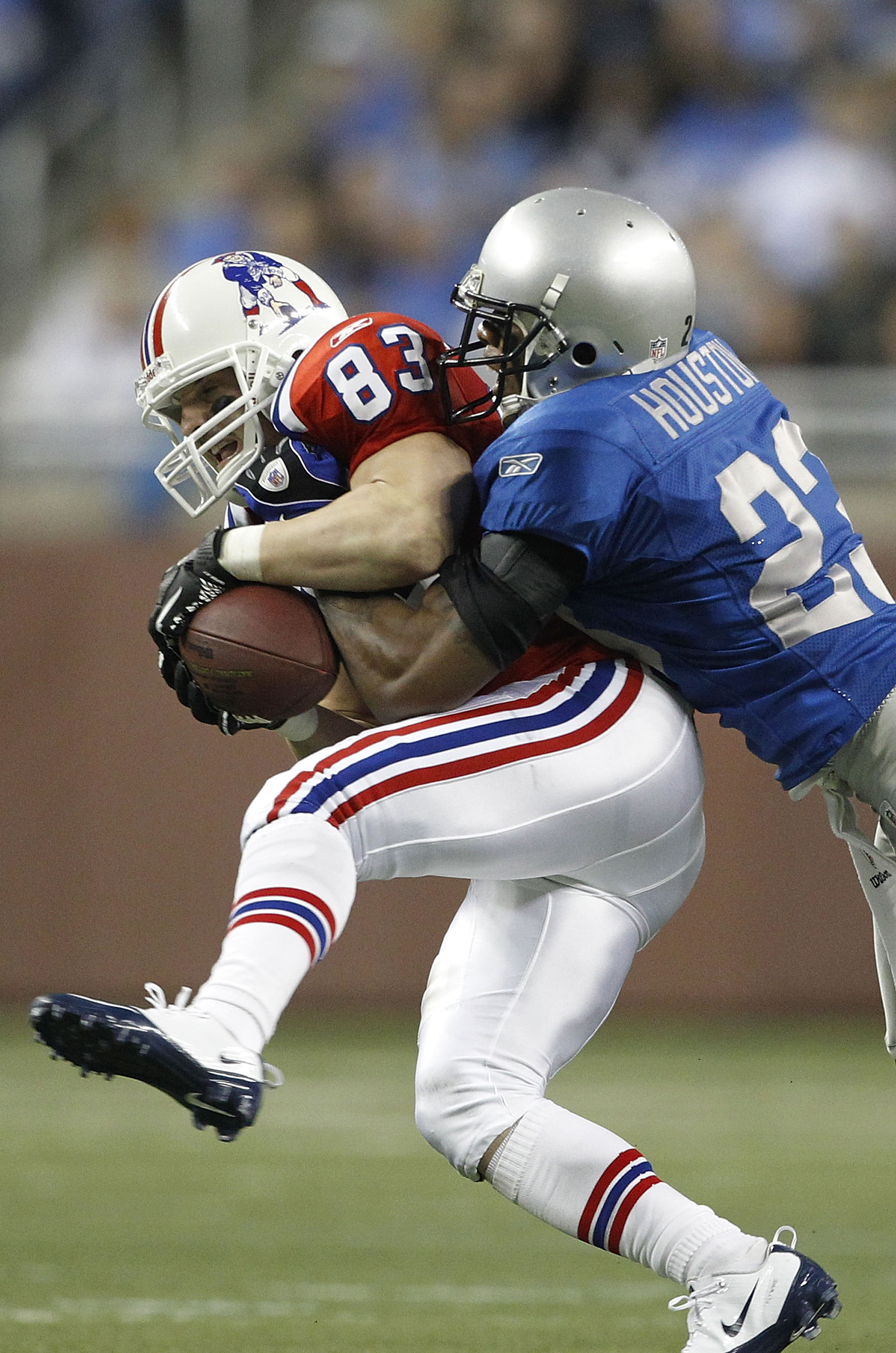 DETROIT - NOVEMBER 25: Chris Houston #23 of the Detroit Lions tackles Wes Welker of the New England Patriots during the game against the Detroit Lions at Ford Field on November 25, 2010 in Detroit, Michigan. New England defeated Detroit 45-24.  (Photo by