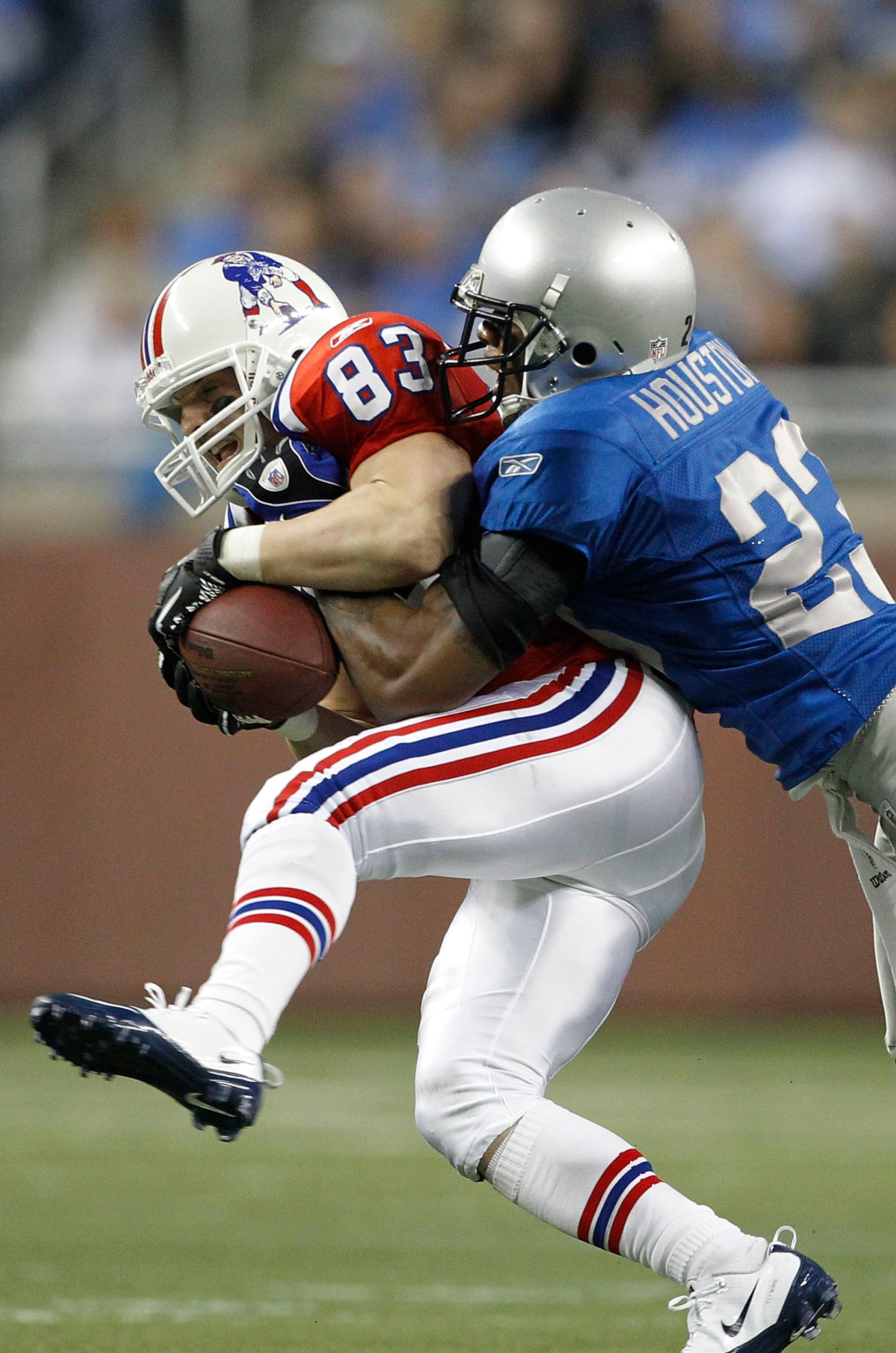 DETROIT - NOVEMBER 25: Chris Houston #23 of the Detroit Lions tackles Wes Welker of the New England Patriots during the game against the Detroit Lions at Ford Field on November 25, 2010 in Detroit, Michigan. New England defeated Detroit 45-24.  (Photo by