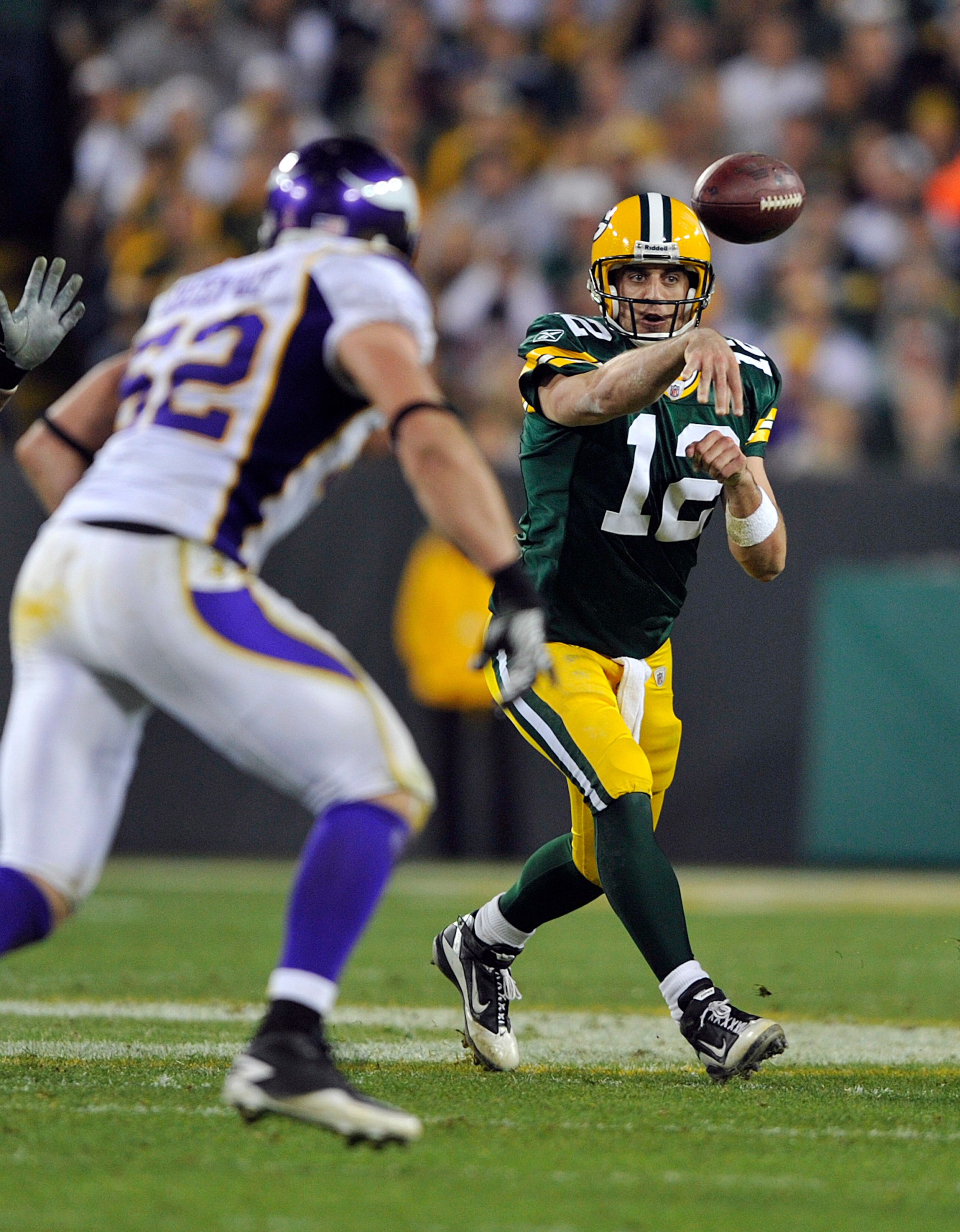 GREEN BAY, WI - OCTOBER 24:  Aaron Rodgers #12 of the Green Bay Packers passes while under pressure from Chad Greenway #52 of the Minnesota Vikings during their game at Lambeau Field on October 24, 2010 in Green Bay, Wisconsin. (Photo by Jim Prisching/Get