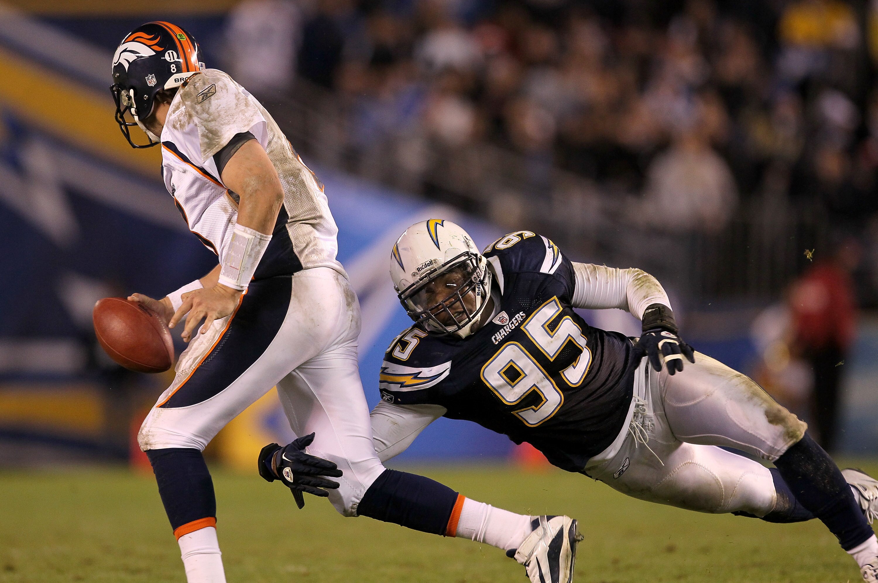 SAN DIEGO - NOVEMBER 22:  Linebacker Shaun Phillips #95 of the San Diego Chargers tackles quarterback Kyle Orton #8 of the Denver Broncos on an unsuccessful fleaflicker play at Qualcomm Stadium on November 22, 2010 in San Diego, California.  (Photo by Ste