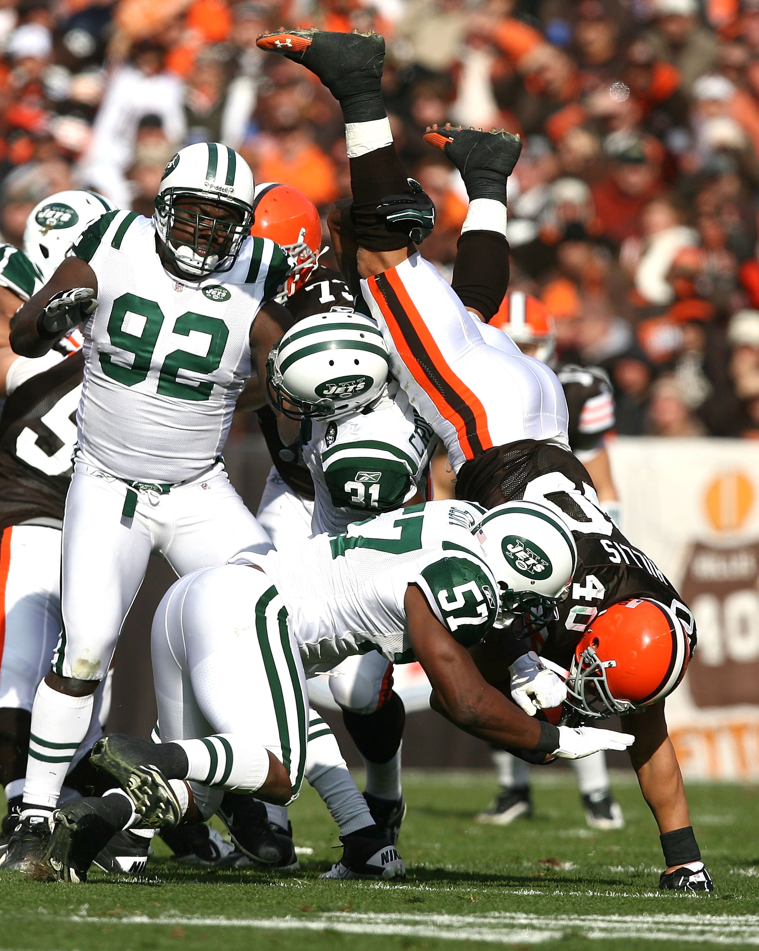 CLEVELAND - NOVEMBER 14:  Tailback Peyton Hillis #40 of the Cleveland Browns is hit by defenders Bart Scott #57 and Antonio Cromartie #31 of the New York Jets at Cleveland Browns Stadium on November 14, 2010 in Cleveland, Ohio.  (Photo by Matt Sullivan/Ge