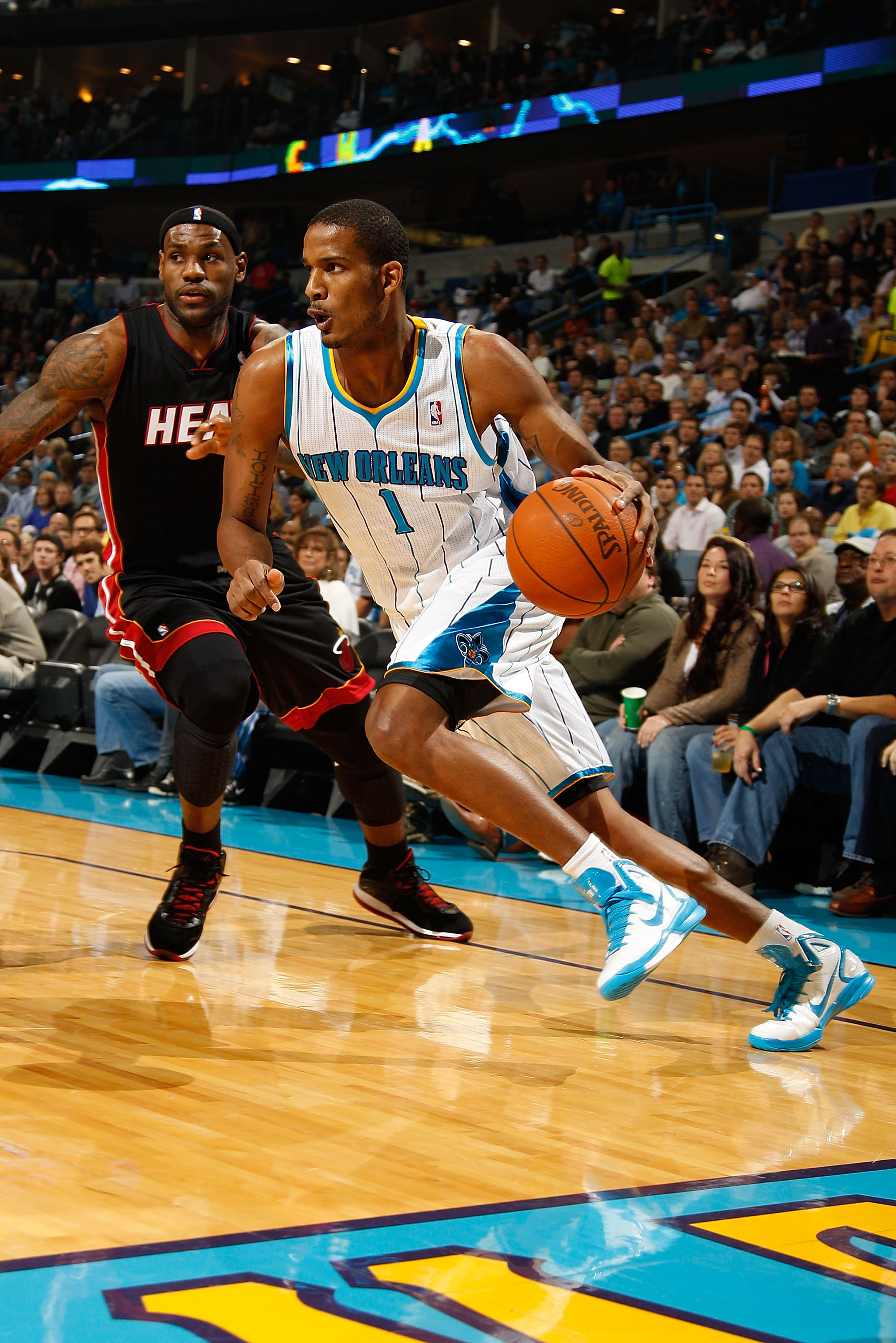 NEW ORLEANS - NOVEMBER 05:  Trevor Ariza #1 of the New Orleans Hornets drives the ball around LeBron James #6 of the Miami Heat at the New Orleans Arena on November 5, 2010 in New Orleans, Louisiana.  NOTE TO USER: User expressly acknowledges and agrees t