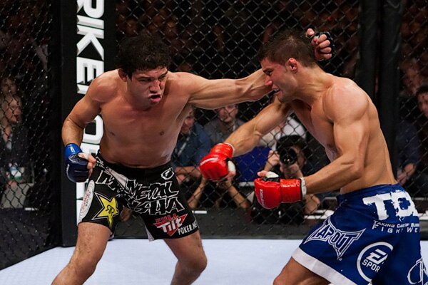 Gilbert Melendez (left) swings wildly with a left hook and misses.