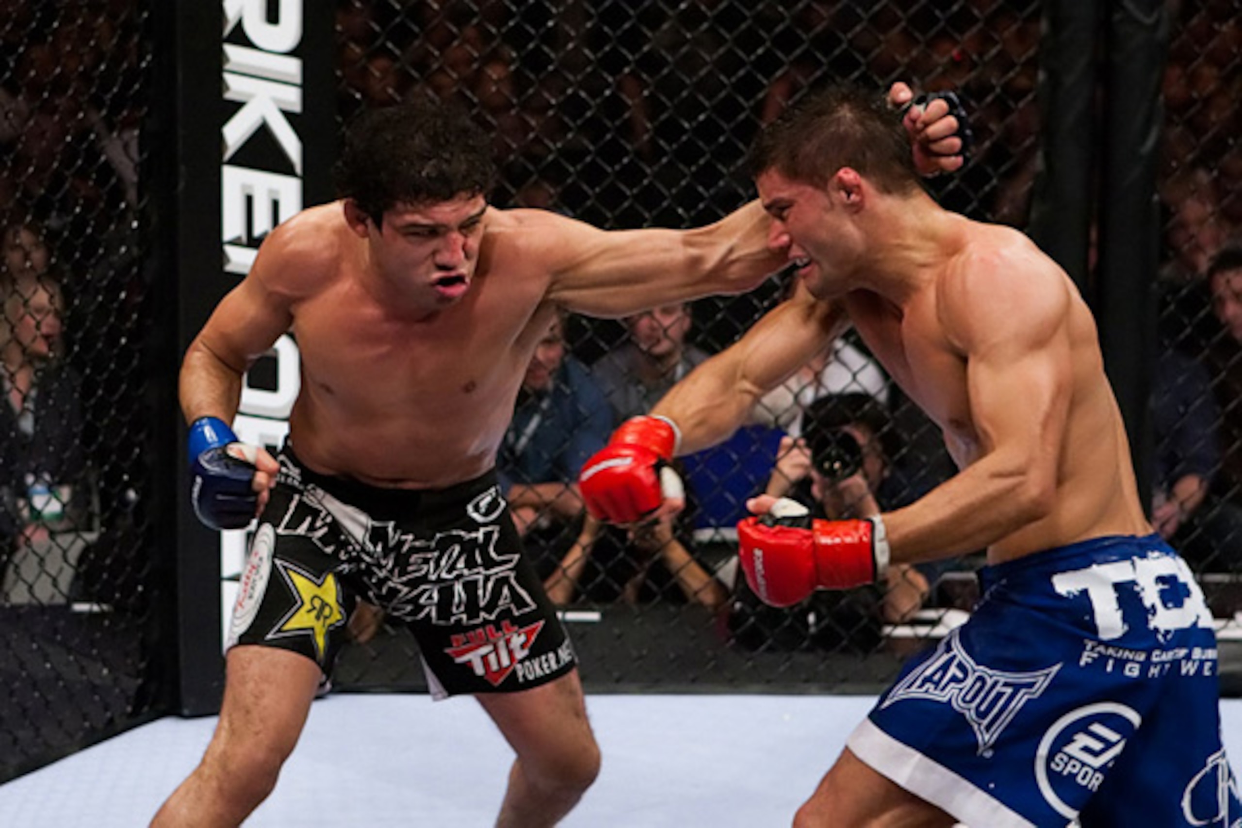Gilbert Melendez (left) swings wildly with a left hook and misses.