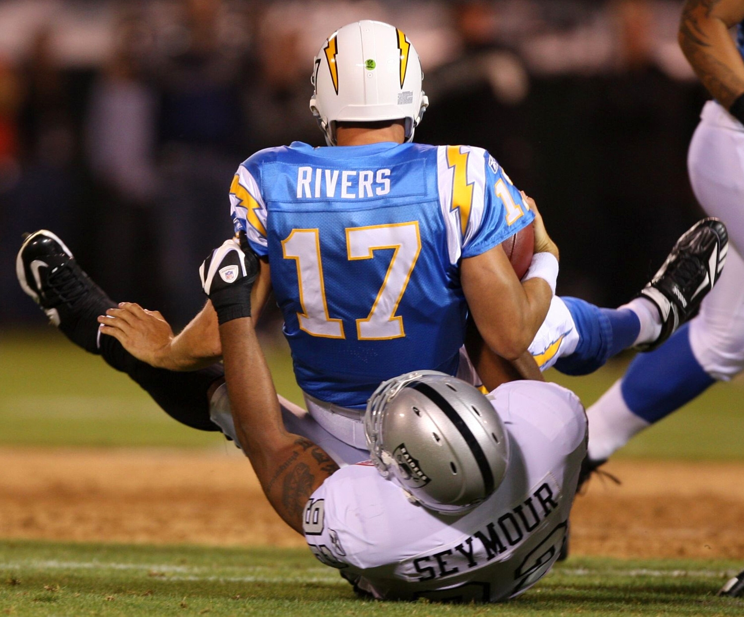 OAKLAND, CA - SEPTEMBER 14:  Philip Rivers #17 of the San Diego Chargers is sacked by Richard Seymour #92 of the Oakland Raiders on September 14, 2009 at the Oakland-Alameda County Coliseum in Oakland, California.  (Photo by Ezra Shaw/Getty Images)