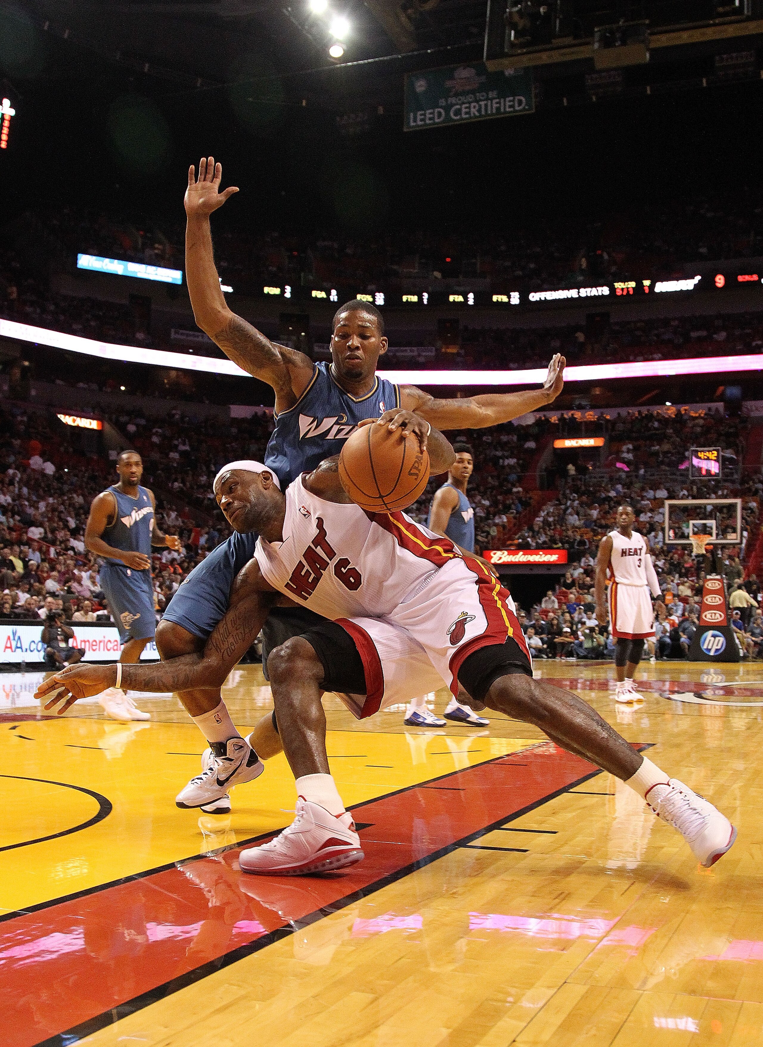 MIAMI, FL - NOVEMBER 29:  LeBron James #6 of the Miami Heat dribbles around Kevin Seraphin #15 of the  Washington Wizards during a game at American Airlines Arena on November 29, 2010 in Miami, Florida. NOTE TO USER: User expressly acknowledges and agrees