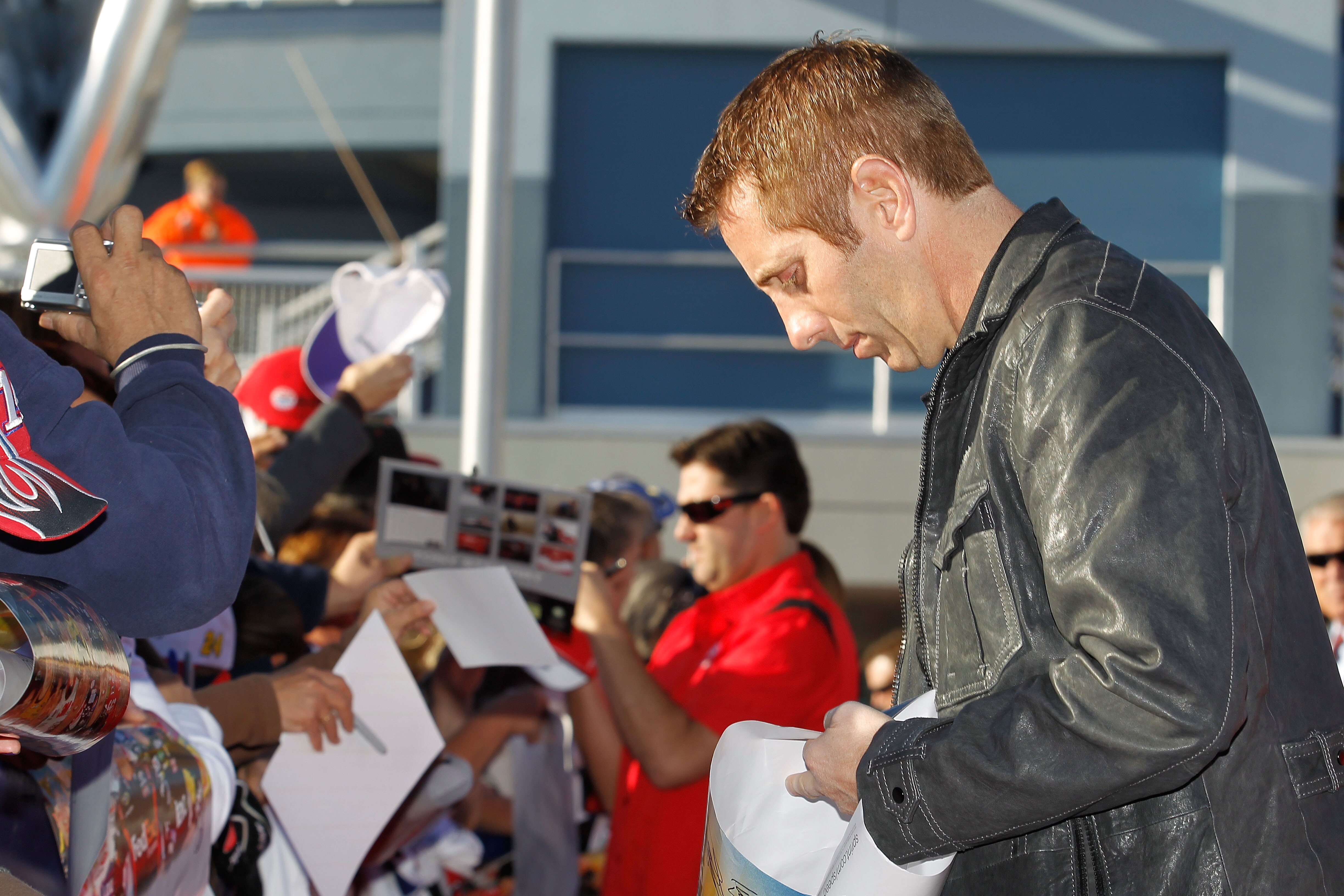 LAS VEGAS, NV - DECEMBER 01:  Greg Biffle (R), driver of the #16 3M Ford, and Tony Stewart (C), driver of the #14 Old Spice/Office Depot Chevrolet, sign autographs during day 2 of the NASCAR Sprint Cup Series Champions Week at Las Vegas Motor Speedway on