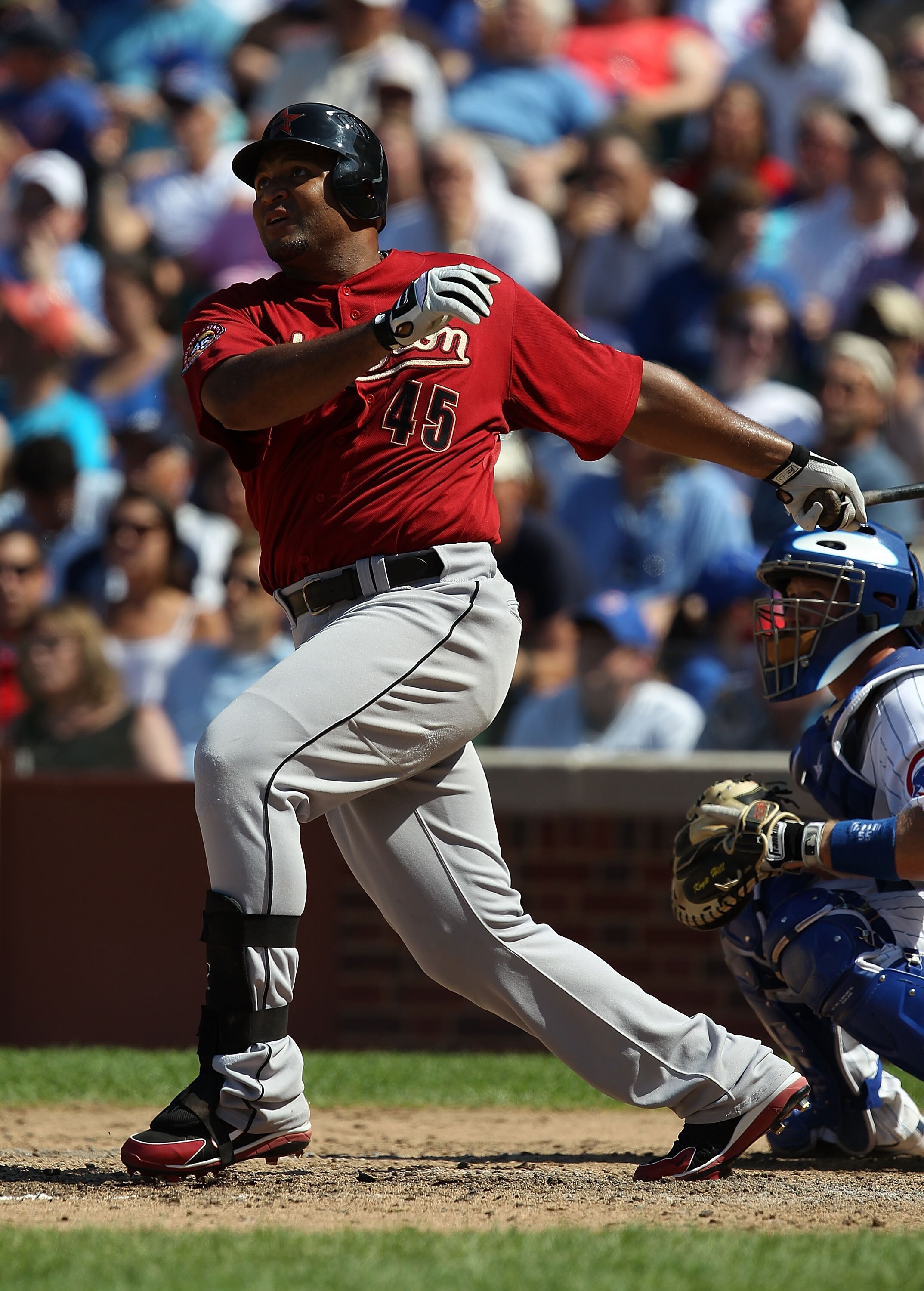 CHICAGO - JULY 21: Carlos Lee #45 of the Houston Astros hits the ball against the Chicago Cubs at Wrigley Field on July 21, 2010 in Chicago, Illinois. The Astros defeated the Cubs 4-3 in 12 innings. (Photo by Jonathan Daniel/Getty Images)
