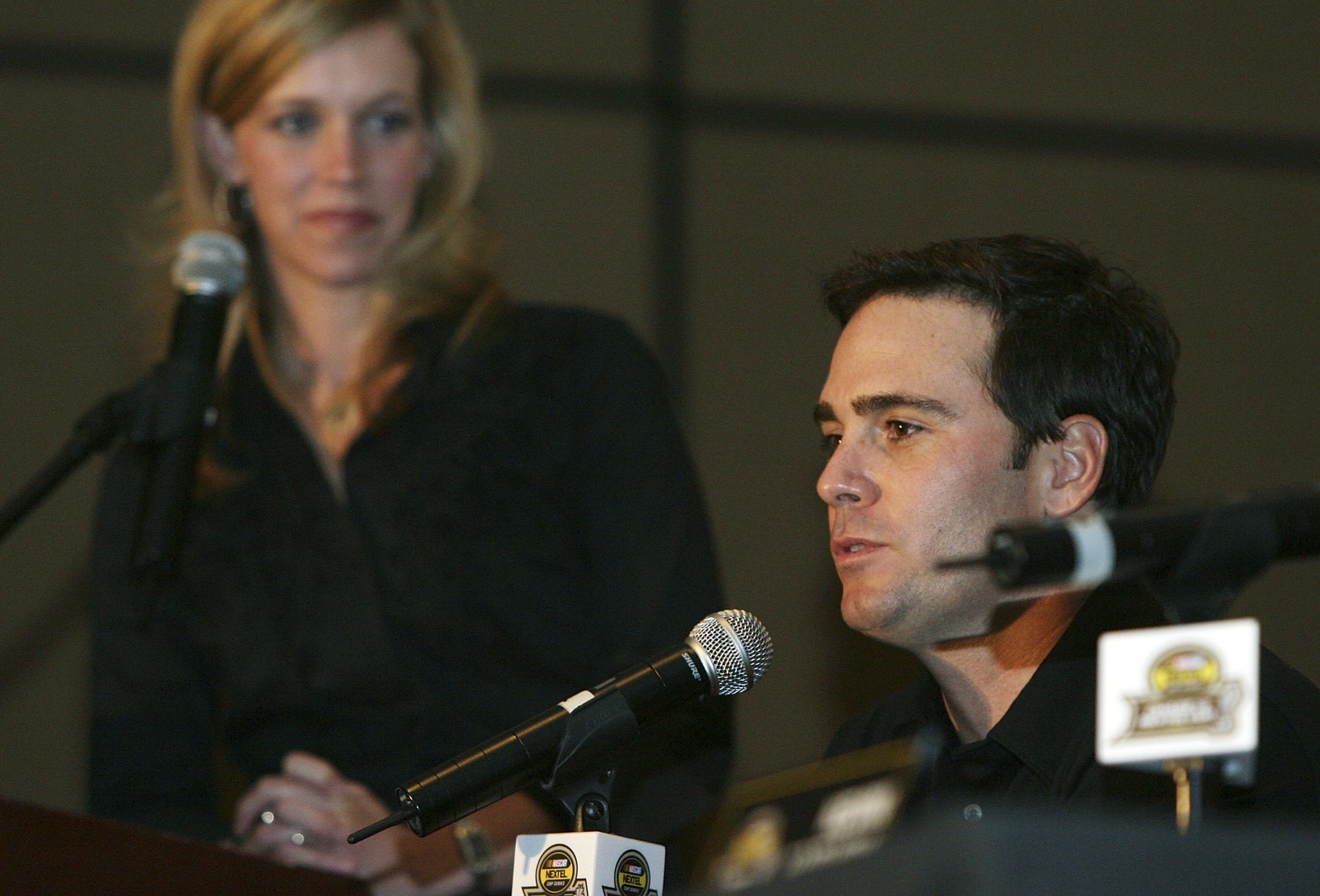 MIAMI - NOVEMBER 16: Moderator Krista Voda of Speed watches chase Jimmie Johnson, driver of the #48 Lowe's Chevrolet as he speaks with reporters during the NASCAR Nextel Cup Chase Contenders Press Conference at the Doral Golf Resort & Spa on November 16,