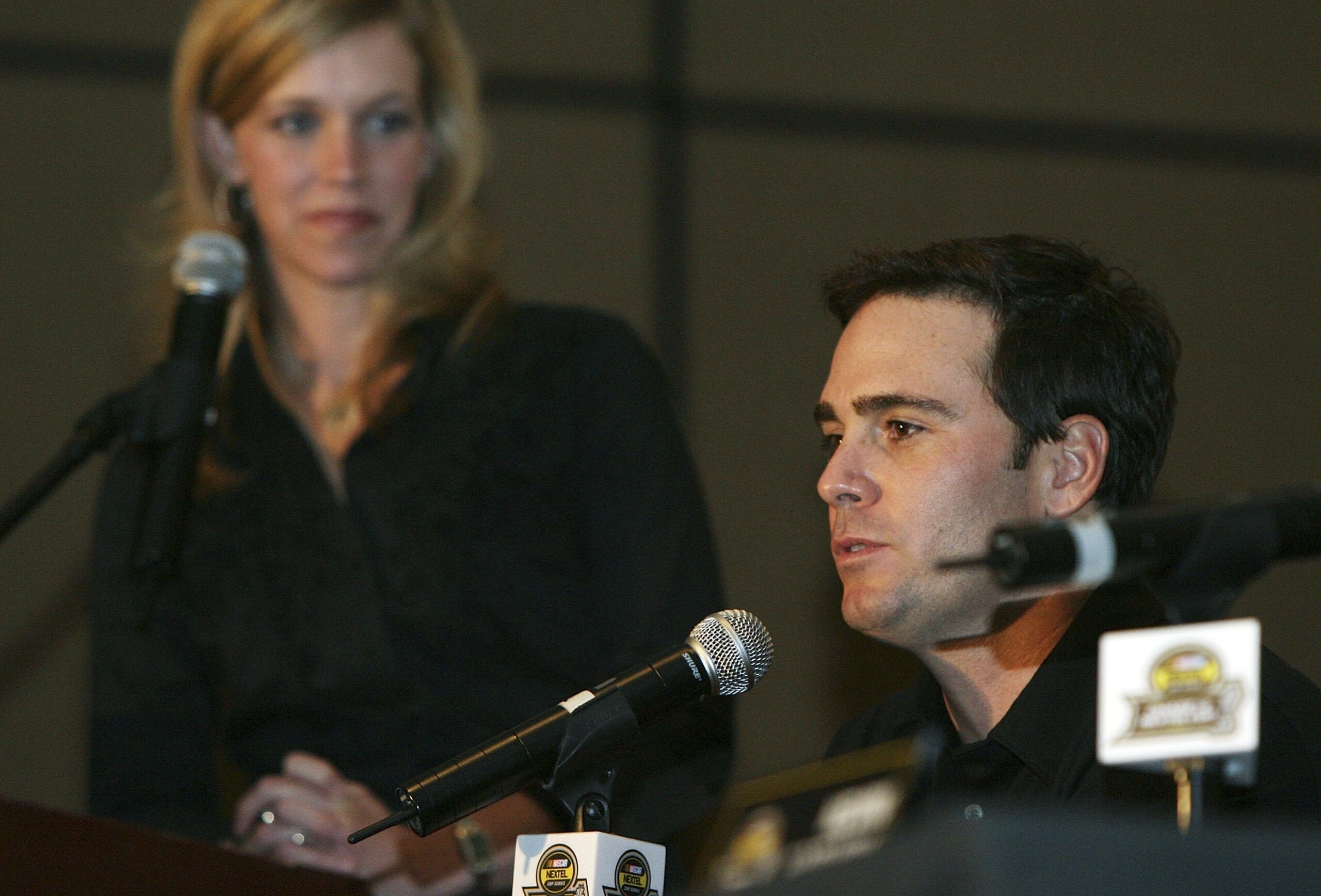 MIAMI - NOVEMBER 16: Moderator Krista Voda of Speed watches chase Jimmie Johnson, driver of the #48 Lowe's Chevrolet as he speaks with reporters during the NASCAR Nextel Cup Chase Contenders Press Conference at the Doral Golf Resort & Spa on November 16,