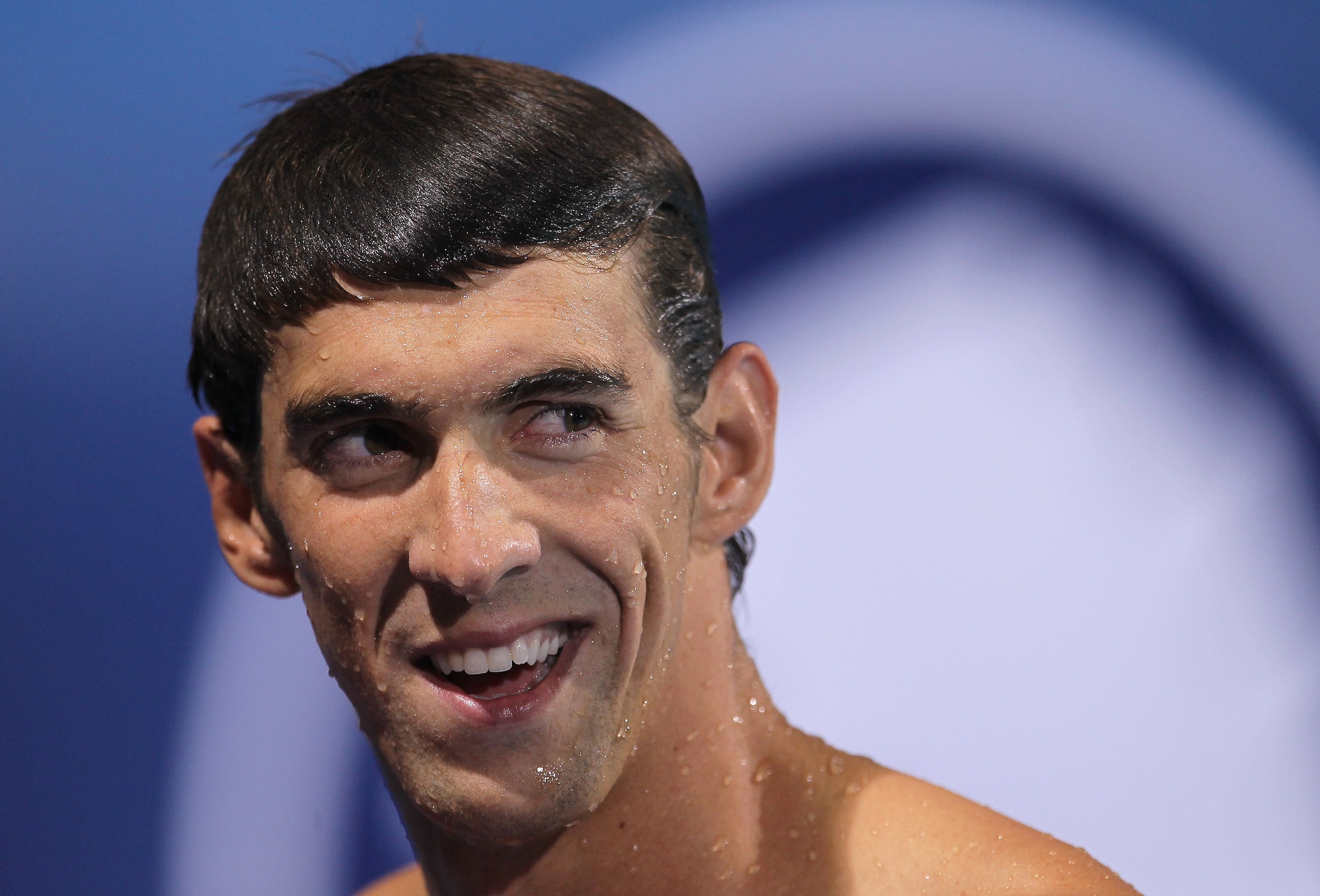 IRVINE, CA - AUGUST 18: Michael Phelps smiles during an interview after winning the men's 200 meter butterfly final during the Mutual of Omaha Pan Pacific Championships at the William Woollett Jr. Aquatic Center on August 18, 2010 in Irvine, California. IRVINE, CA - AUGUST 18: Michael Phelps smiles during an interview after winning the men's 200 meter butterfly final during the Mutual of Omaha Pan Pacific Championships at the William Woollett Jr. Aquatic Center on August 18, 2010 in Irvine, California.