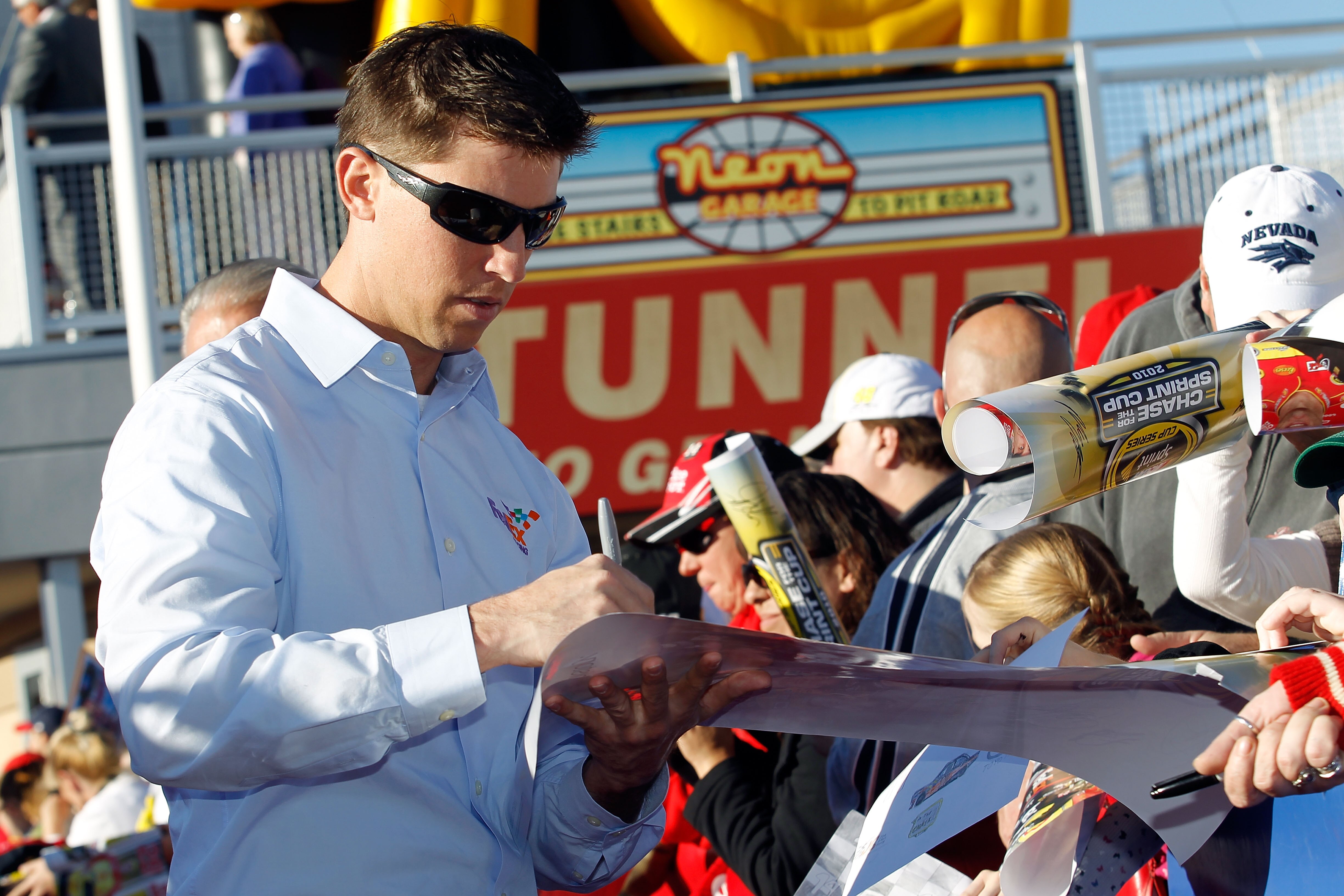 LAS VEGAS, NV - DECEMBER 01:  Denny Hamlin (L), driver of the #11 FedEx Toyota, signs autographs during day 2 of the NASCAR Sprint Cup Series Champions Week at Las Vegas Motor Speedway on December 1, 2010 in Las Vegas, Nevada.  (Photo by Todd Warshaw/Gett