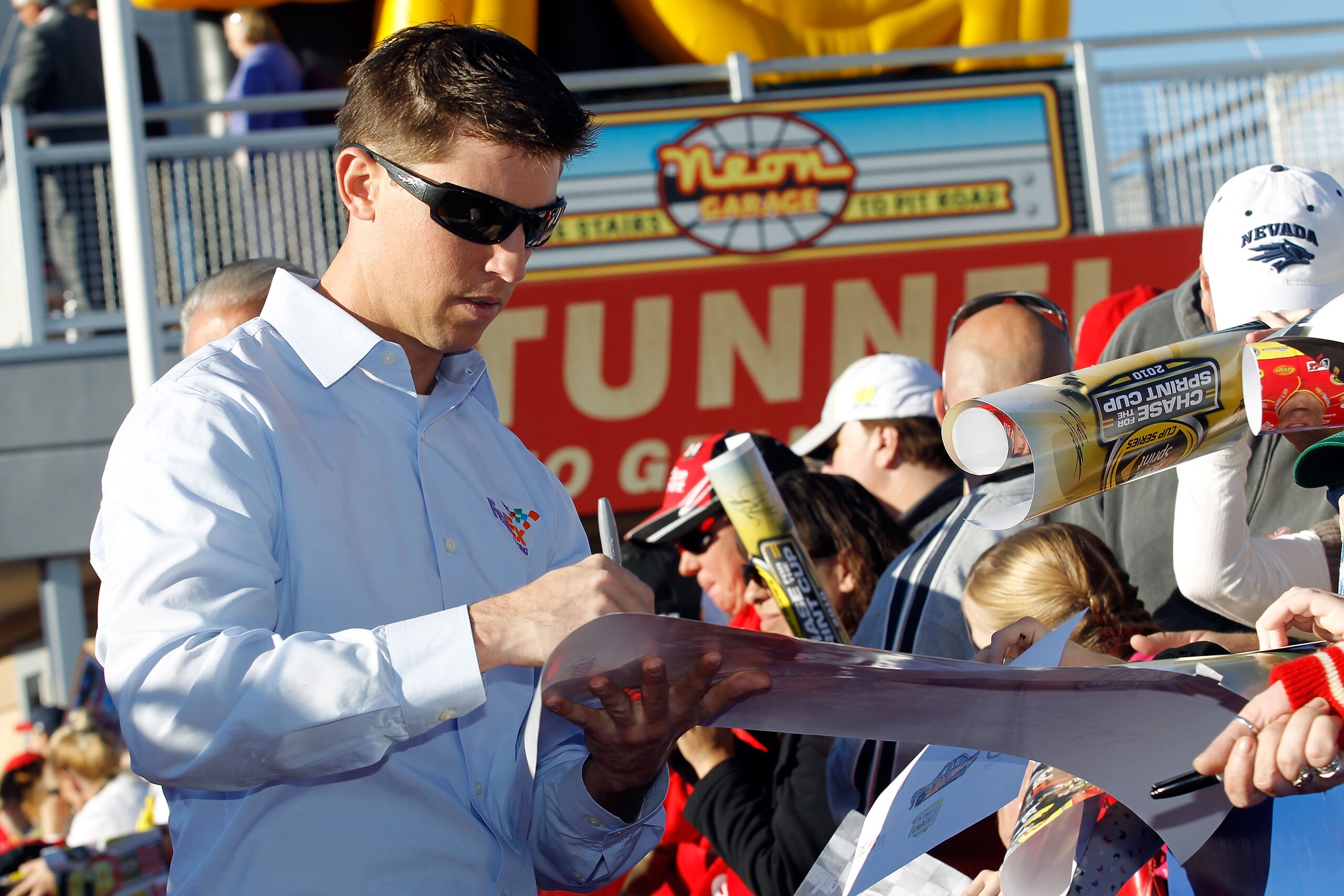LAS VEGAS, NV - DECEMBER 01:  Denny Hamlin (L), driver of the #11 FedEx Toyota, signs autographs during day 2 of the NASCAR Sprint Cup Series Champions Week at Las Vegas Motor Speedway on December 1, 2010 in Las Vegas, Nevada.  (Photo by Todd Warshaw/Gett