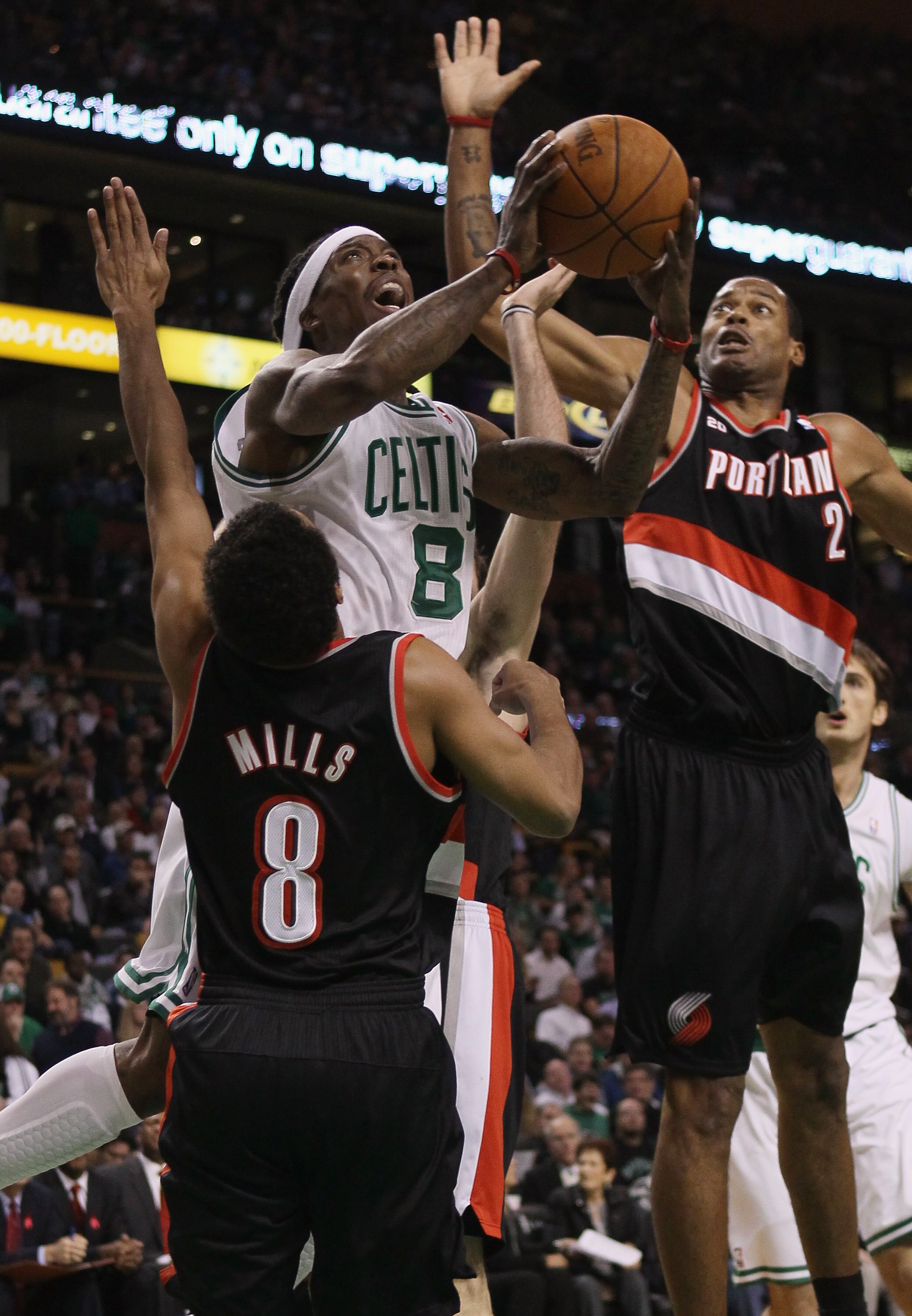 BOSTON - DECEMBER 01:  Marquis Daniels #8 of the Boston Celtics tries to take a shot as Marcus Camby #23 and Patrick Mills #8 of the Portland Trailblazers defend on December 1, 2010 at the TD Garden in Boston, Massachusetts.  NOTE TO USER: User expressly