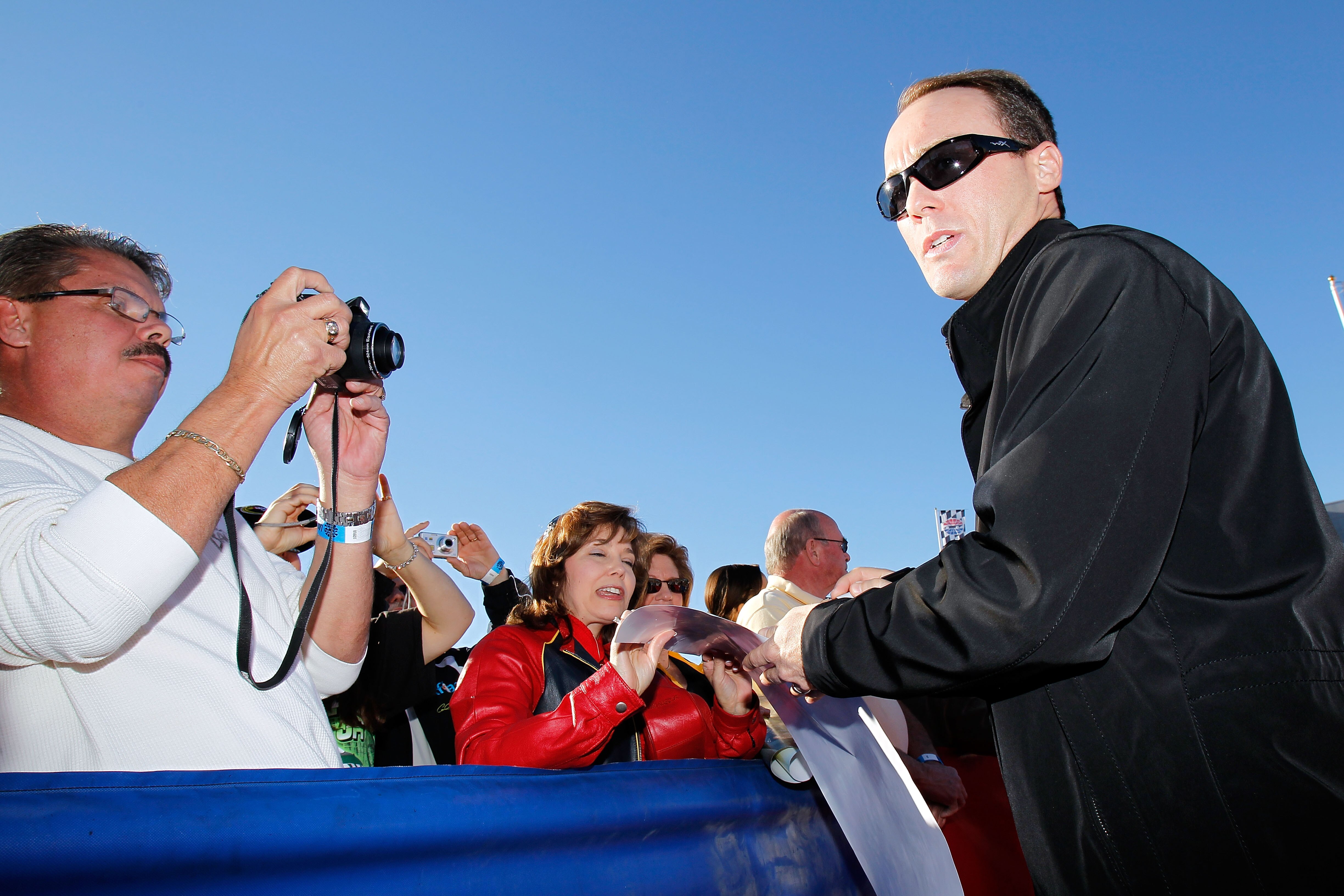 LAS VEGAS, NV - DECEMBER 01:  Kevin Harvick (R), driver of the #29 Shell/Pennzoil Chevrolet, signs autographs during day 2 of the NASCAR Sprint Cup Series Champions Week at Las Vegas Motor Speedway on December 1, 2010 in Las Vegas, Nevada.  (Photo by Todd