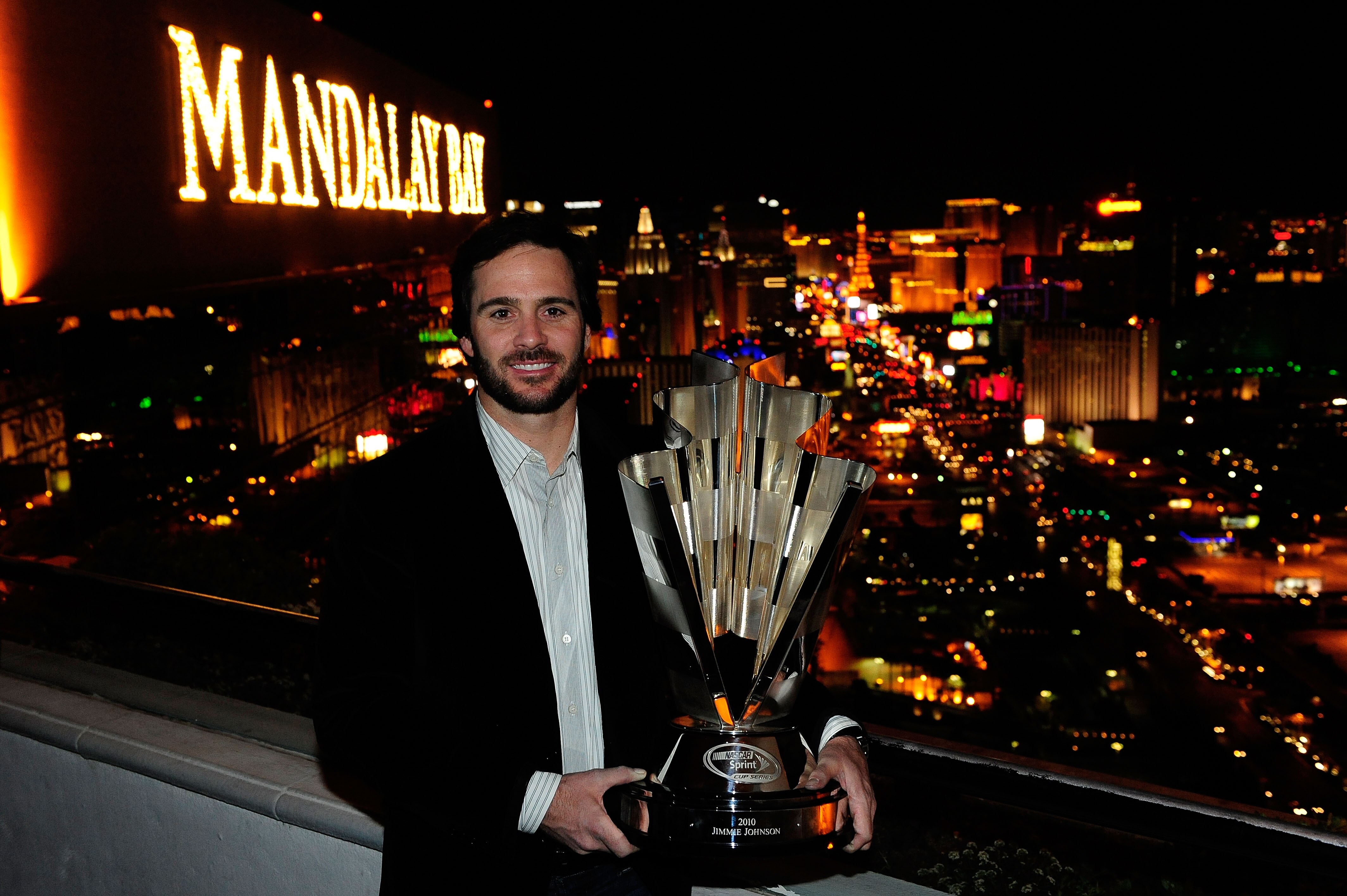 LAS VEGAS, NV - NOVEMBER 30:  Five-time NASCAR Sprint Cup Series Champion Jimmie Johnson poses with the 2010 trophy at the House of Blues Foundation Room inside Mandalay Bay Resort & Casino during Day 1 of the NASCAR Sprint Cup Series Champions Week on No