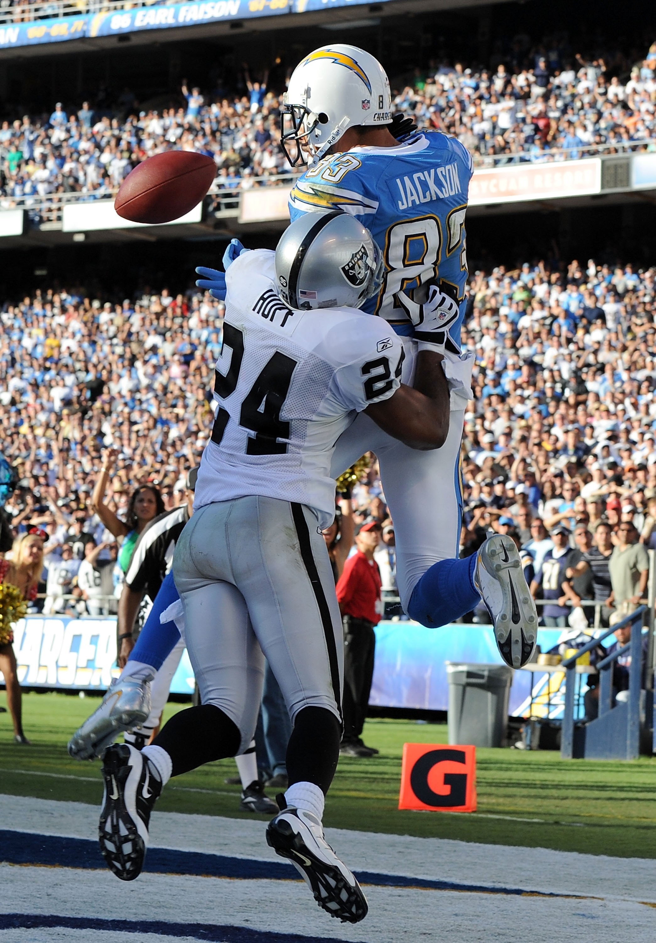 SAN DIEGO - NOVEMBER 01:  Vincent Jackson #83 of the San Diego Chargers has the ball knocked out by Michael Huff #24 of the Oakland Raiders during the game at Qualcomm Stadium on November 1, 2009 in San Diego California. The Chargers defeated the Raiders