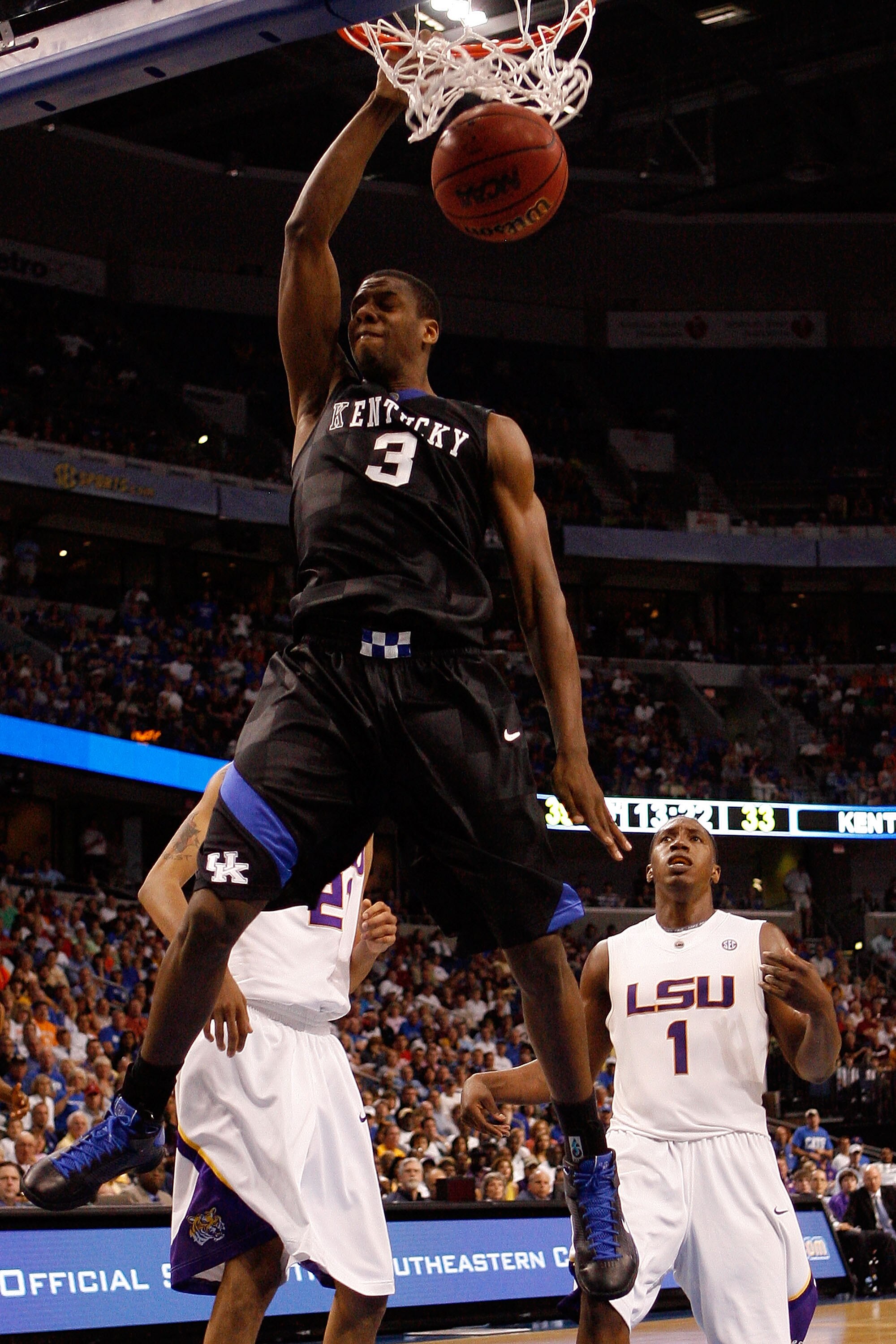 TAMPA, FL - MARCH 13:  Kevin Galloway #3 of the Kentucky Wildcats dunks the ball over Tasmin Mitchell #1 of the Louisiana State University Tigers during the second round of the SEC Men's Basketball Tournament on March 13, 2009 at The St. Pete Times Forum 