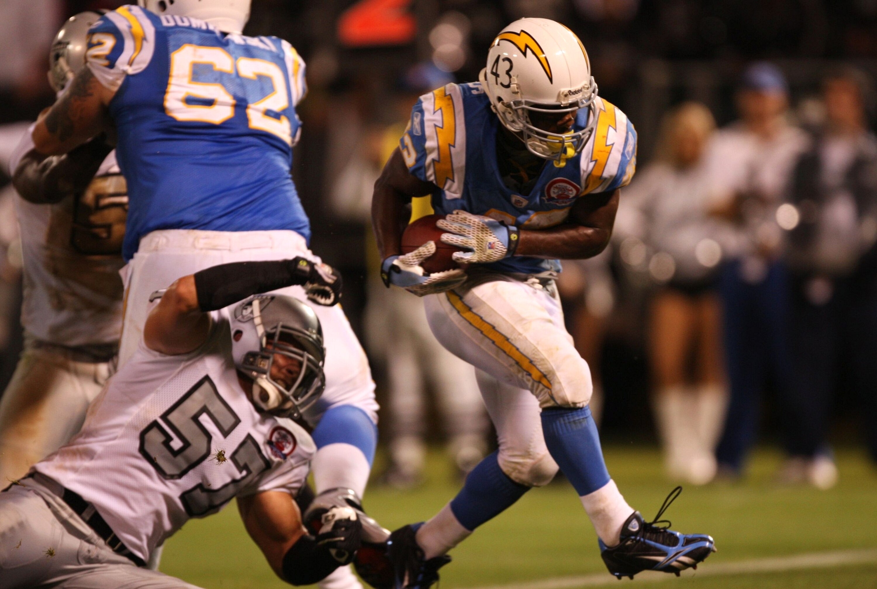 OAKLAND, CA - SEPTEMBER 14:  Darren Sproles #43 of the San Diego Chargers scores the game-winning touchdown on a 5-yard rushing TD in the fourth quarter against Ricky Brown #57 of the Oakland Raiders on September 14, 2009 at the Oakland-Alameda County Col