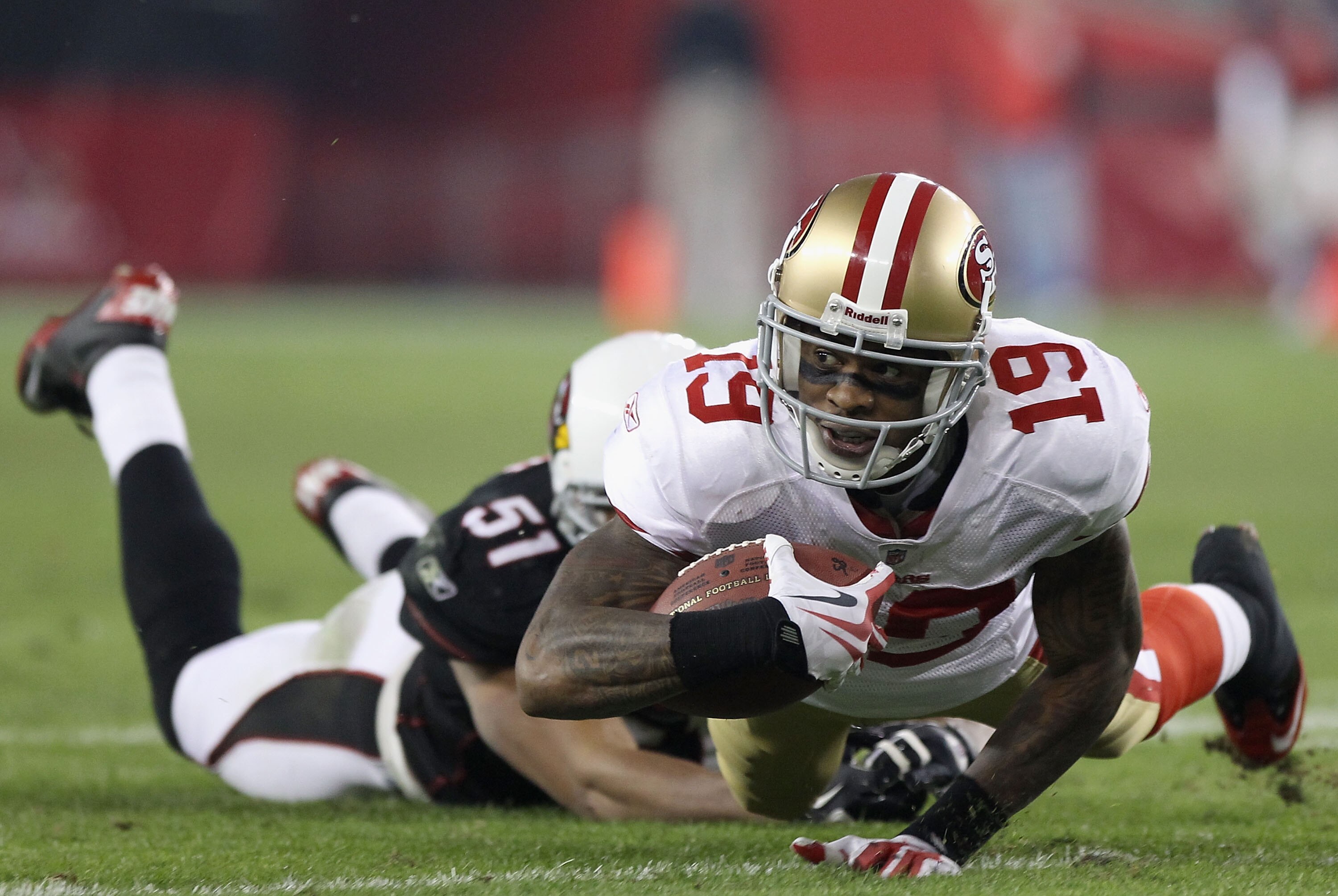 GLENDALE, AZ - NOVEMBER 29:  Wide receiver Ted Ginn Jr. #19 of the San Francisco 49ers dives for extra yards after a reception past Paris Lenon #51 of the Arizona Cardinals during the NFL game at the University of Phoenix Stadium on November 29, 2010 in G