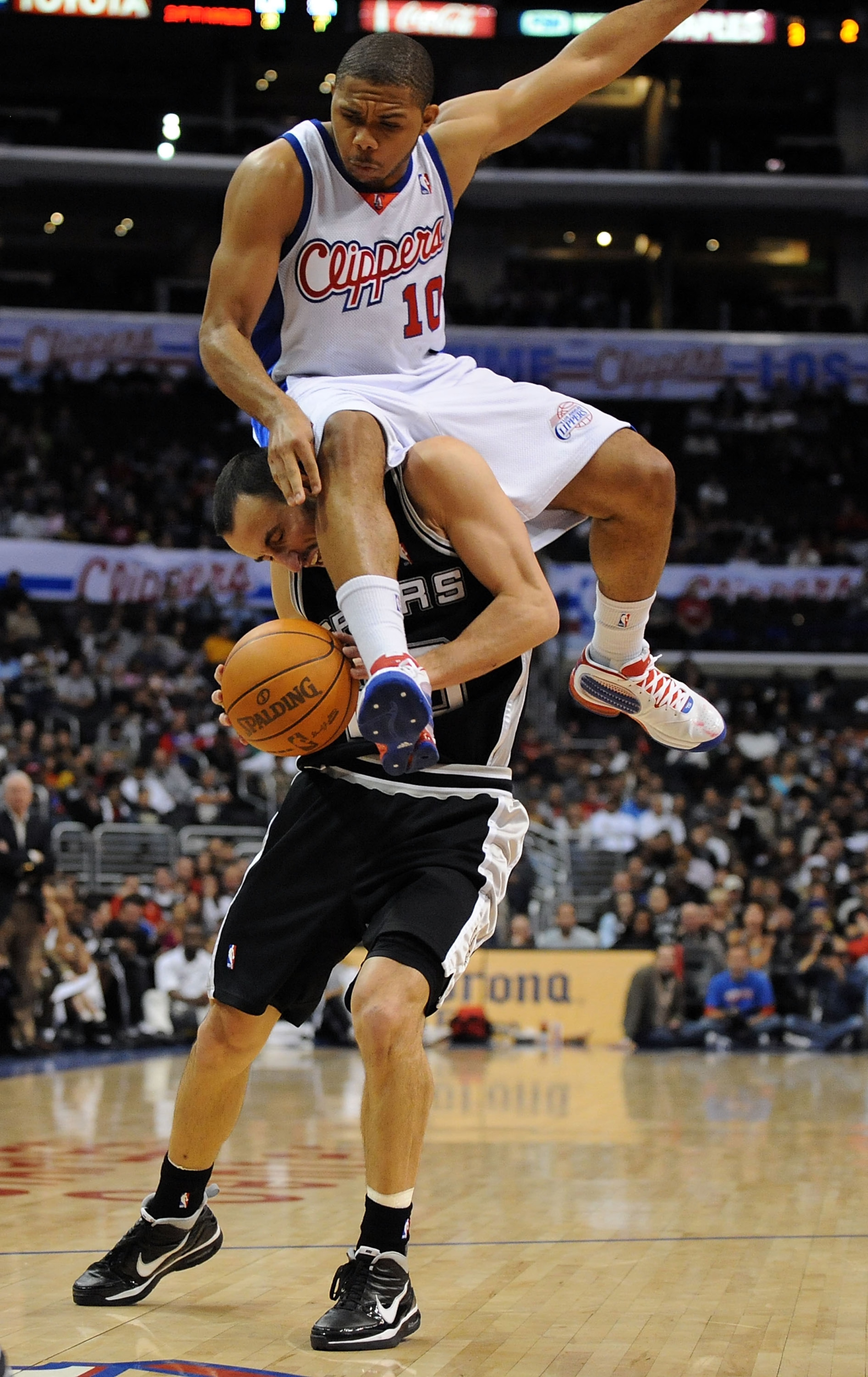 LOS ANGELES, CA - DECEMBER 13: Eric Gordon #10 of the Los Angeles Clippers lands on Manu Ginobili #20 of the San Antonio Spurs attempting to block his shot during the game at Staples Center on December 13, 2009 in Los Angeles, California. The Spurs won LOS ANGELES, CA - DECEMBER 13: Eric Gordon #10 of the Los Angeles Clippers lands on Manu Ginobili #20 of the San Antonio Spurs attempting to block his shot during the game at Staples Center on December 13, 2009 in Los Angeles, California. The Spurs won